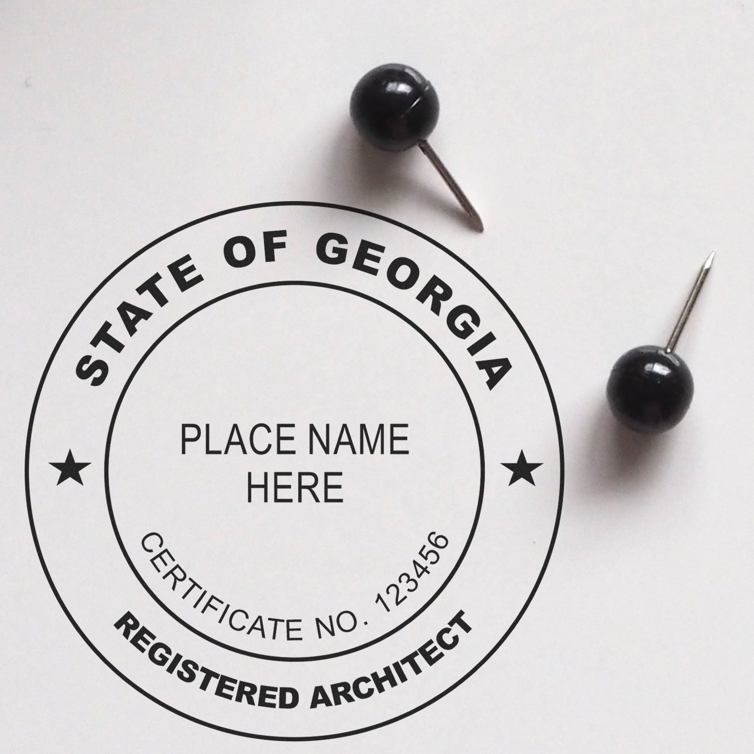 Feature image for blog post 'Compliance Made Easy: Mastering Georgia Architect Stamp Laws' showing a Georgia architect stamp with two push pins.