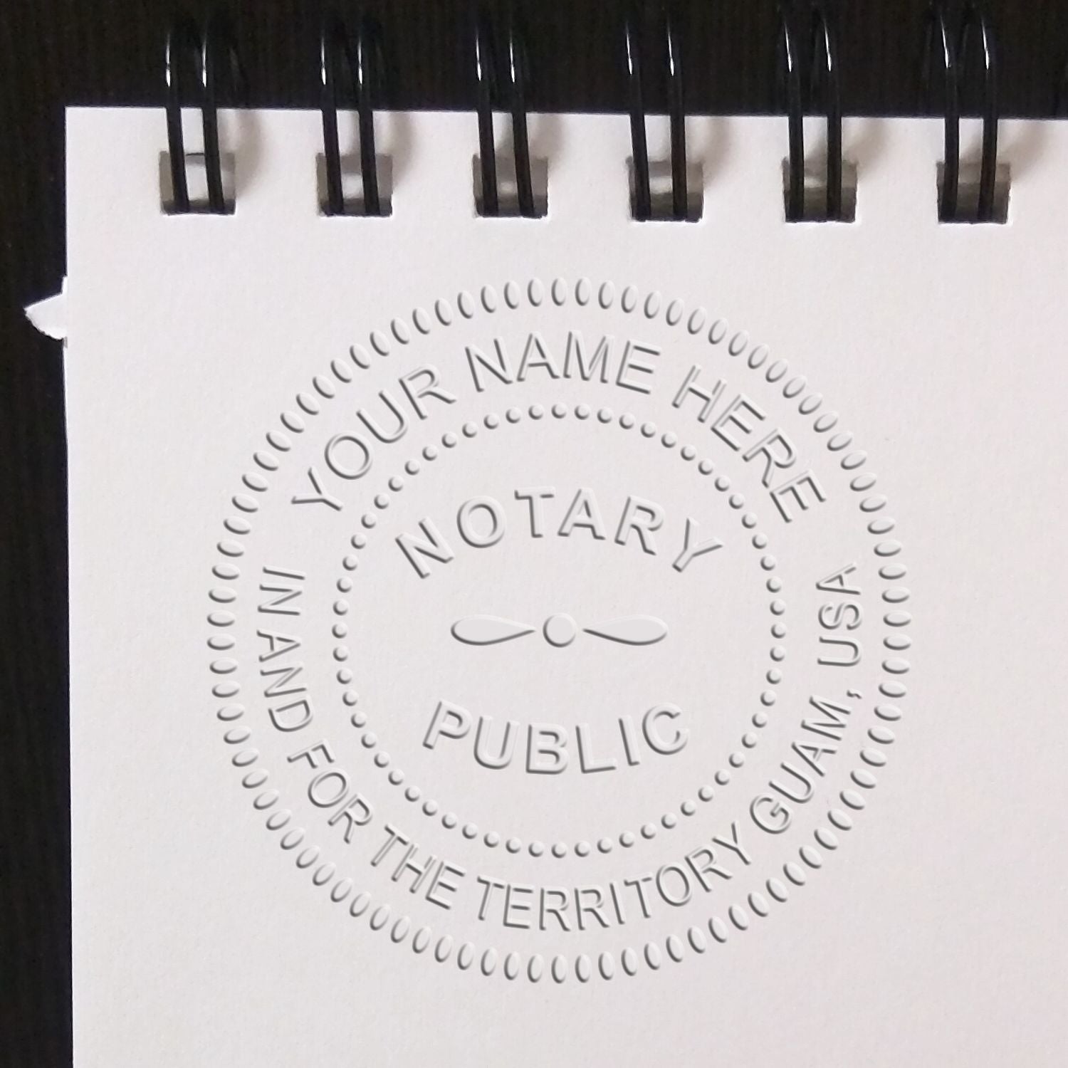 Ink Matters: The Key to a Legally Binding Stamp Feature Image - Close-up of a notary public stamp imprint on a spiral-bound notepad.