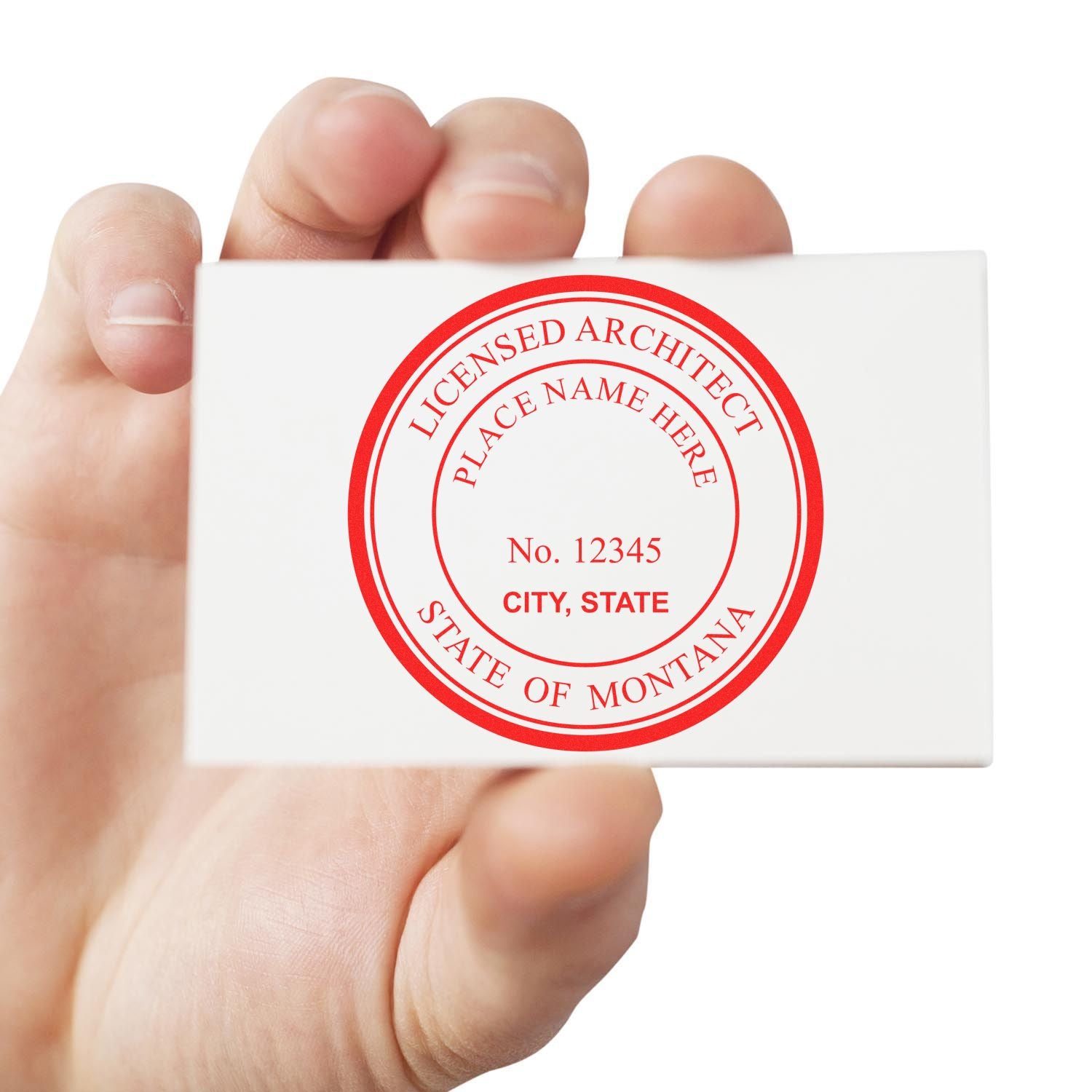 Hand holding a white card with a red circular stamp reading Licensed Architect, State of Montana. Blog post: Sealing Excellence: Premium Montana Architect Stamp Designs.