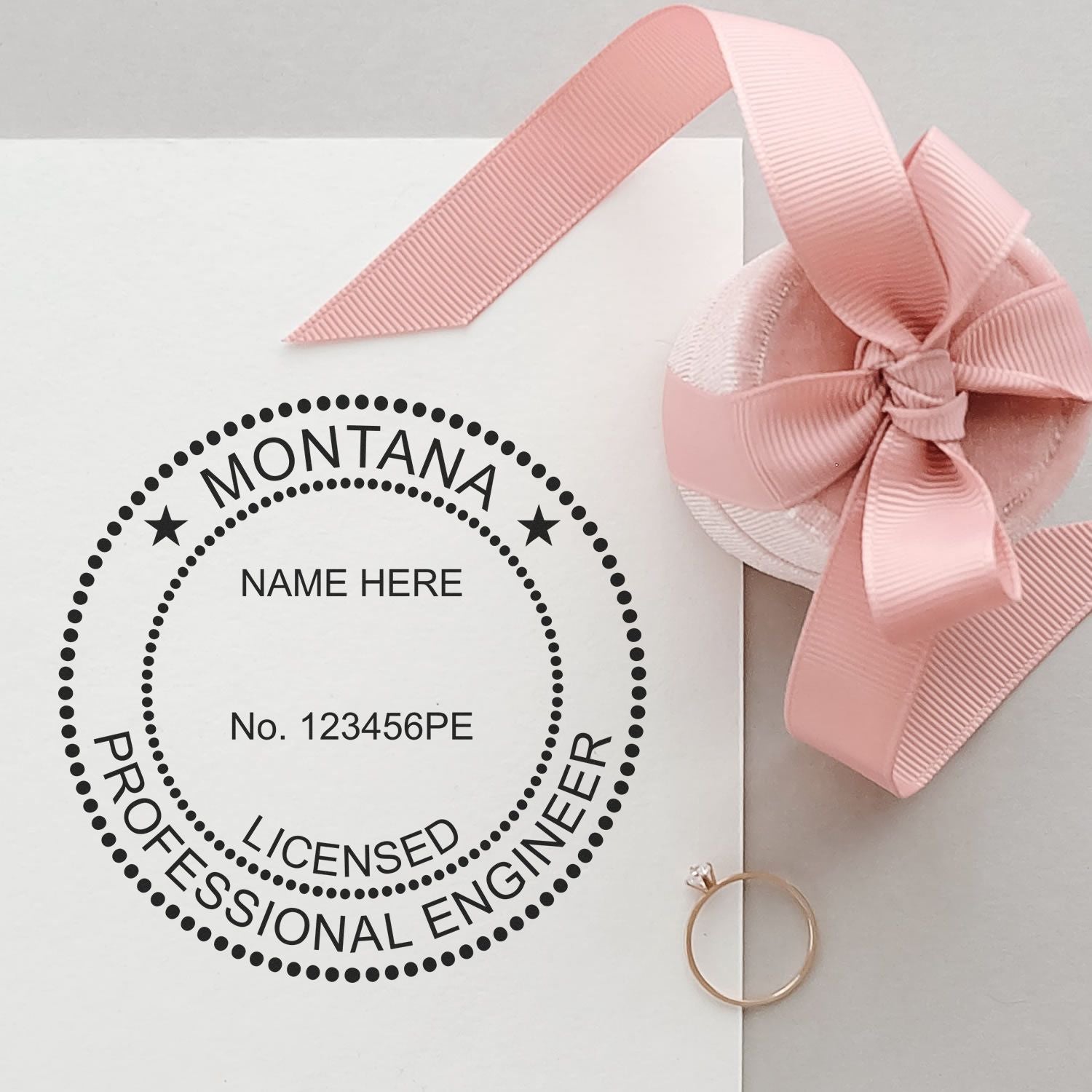 Image of a PE stamp with text MONTANA LICENSED PROFESSIONAL ENGINEER next to a pink ribbon and ring. Blog post: Avoid Costly Mistakes: Mastering PE Stamp Requirements Feature Post Image.