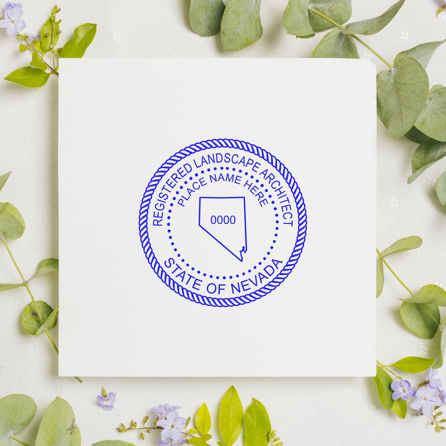 Nevada Landscape Architect Feature Image: Blue Nevada landscape architect seal stamp on white paper, surrounded by green leaves and small flowers.