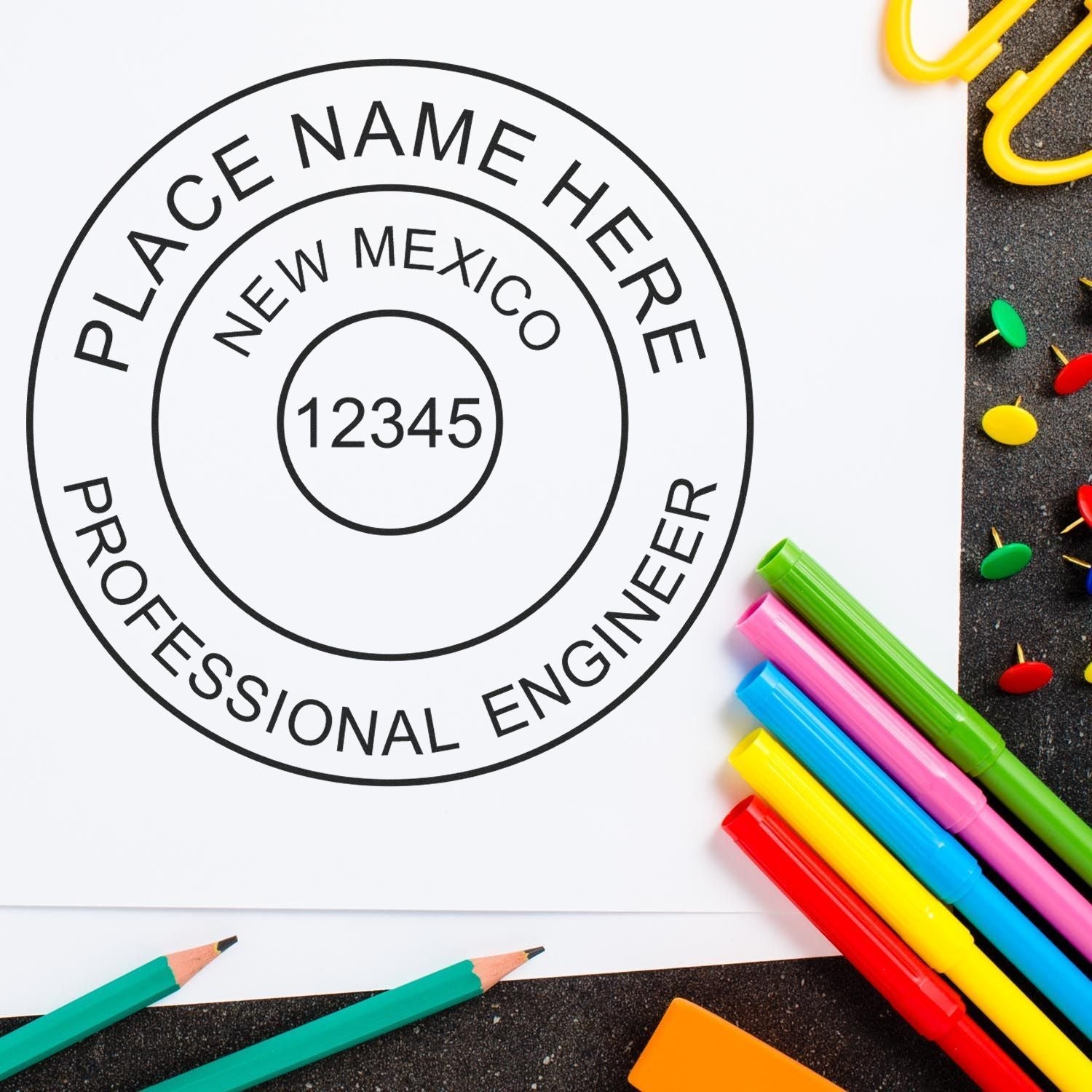 Image of a New Mexico PE stamp on paper with colorful pens and pins. Blog post: The Ultimate Guide to New Mexico PE Stamp Regulations Feature Image.