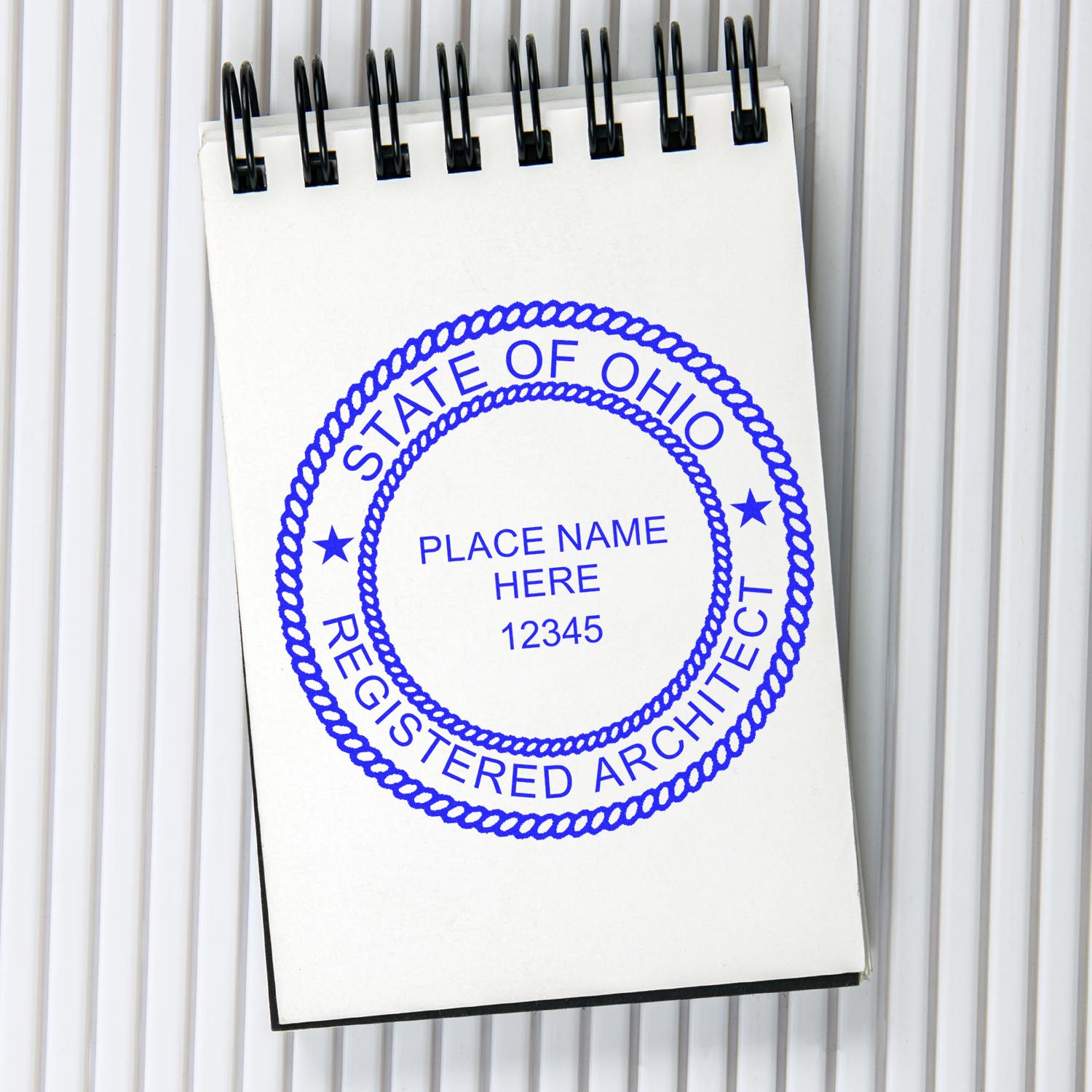 Feature image for blog post 'Ohio Architect Stamp 101: Your Go-To Guide on Seal Guidelines' showing an Ohio architect stamp on a notepad.