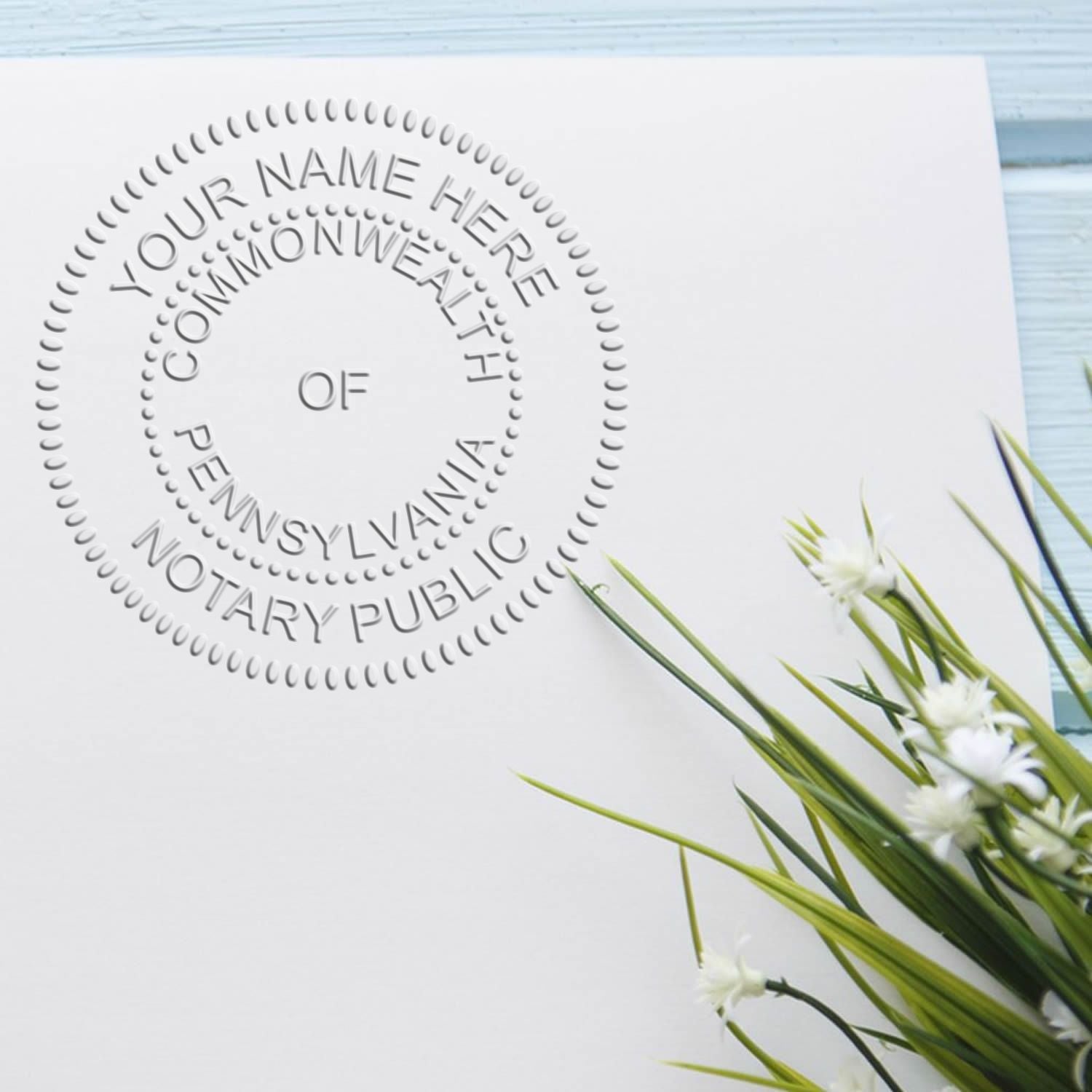 Right Size Matters: Choosing the Perfect Notary Stamp Size Feature Image - Pennsylvania notary public round stamp on white paper with flowers.