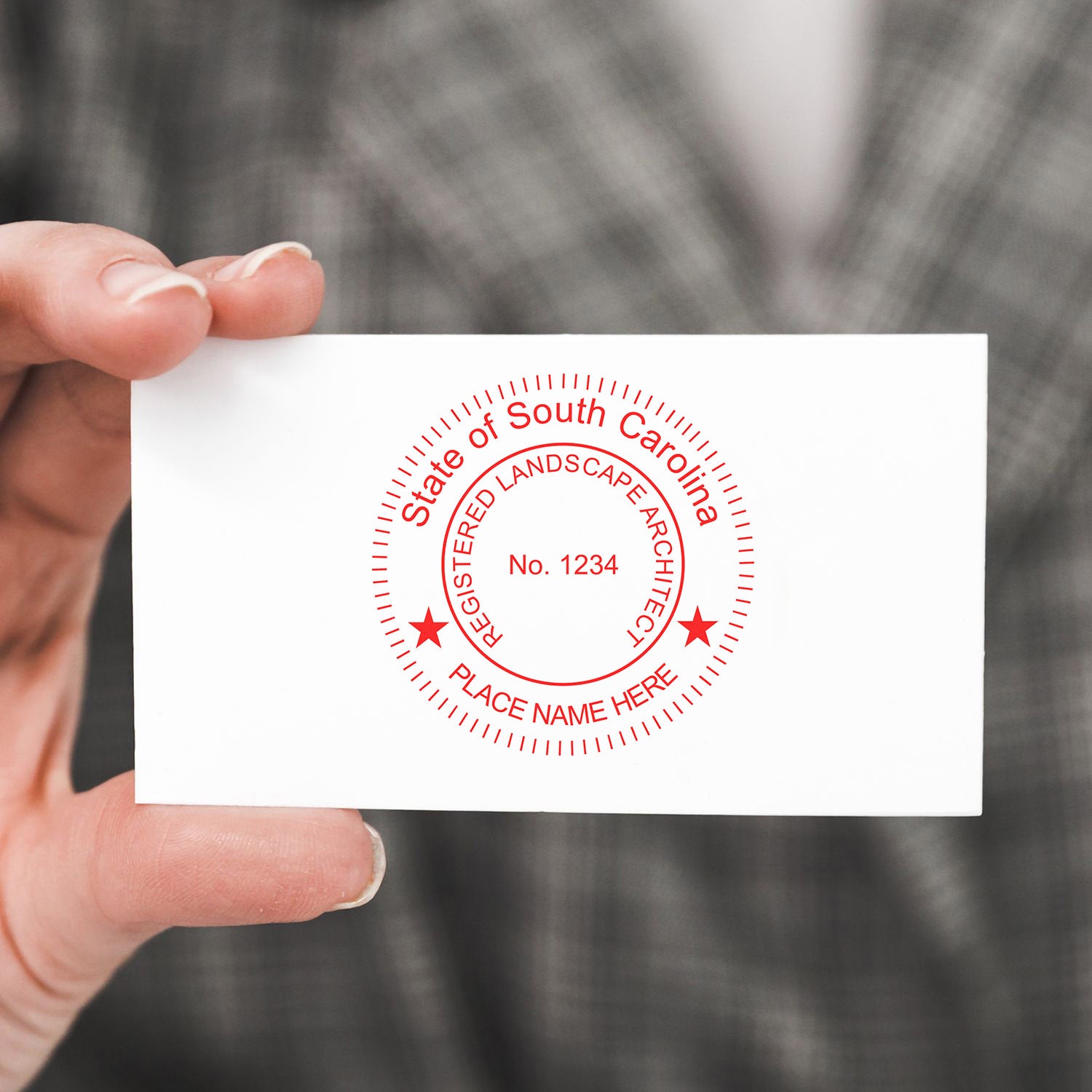 Person holding a card with a red State of South Carolina Registered Landscape Architect seal. Blog post: South Carolina Landscape Architect Feature Image.