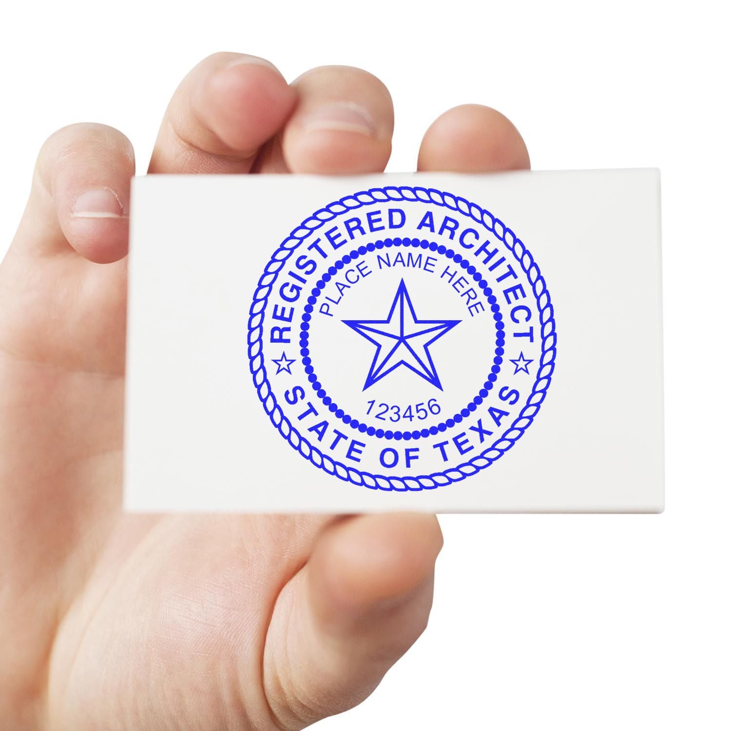 Hand holding a card with a blue Texas Registered Architect stamp. Blog post: Demystifying Texas Architect Stamp Rules: A Clear Picture Feature Image.