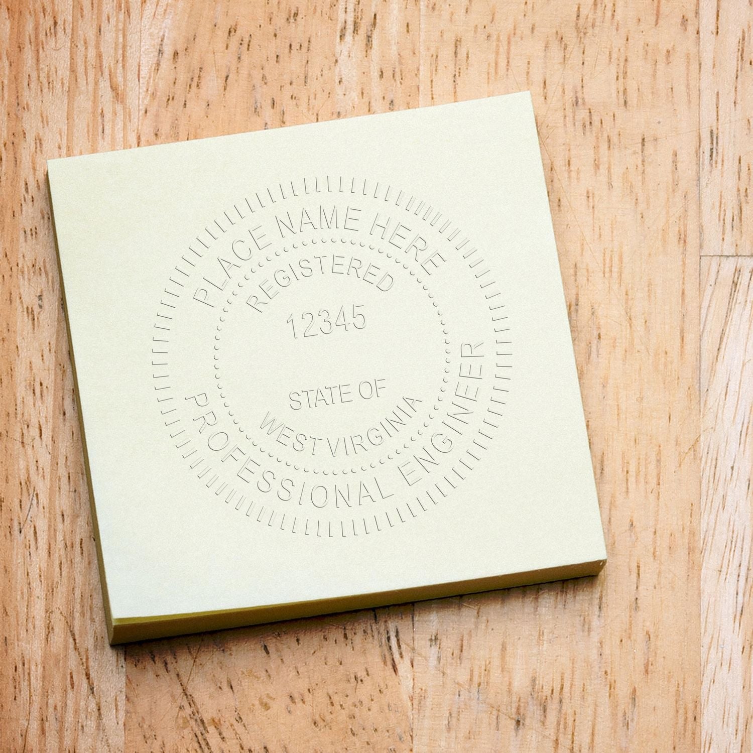 West Virginia Professional Embosser blog post: A close-up of a West Virginia engineer embossing seal on a light green paper on a wooden surface.