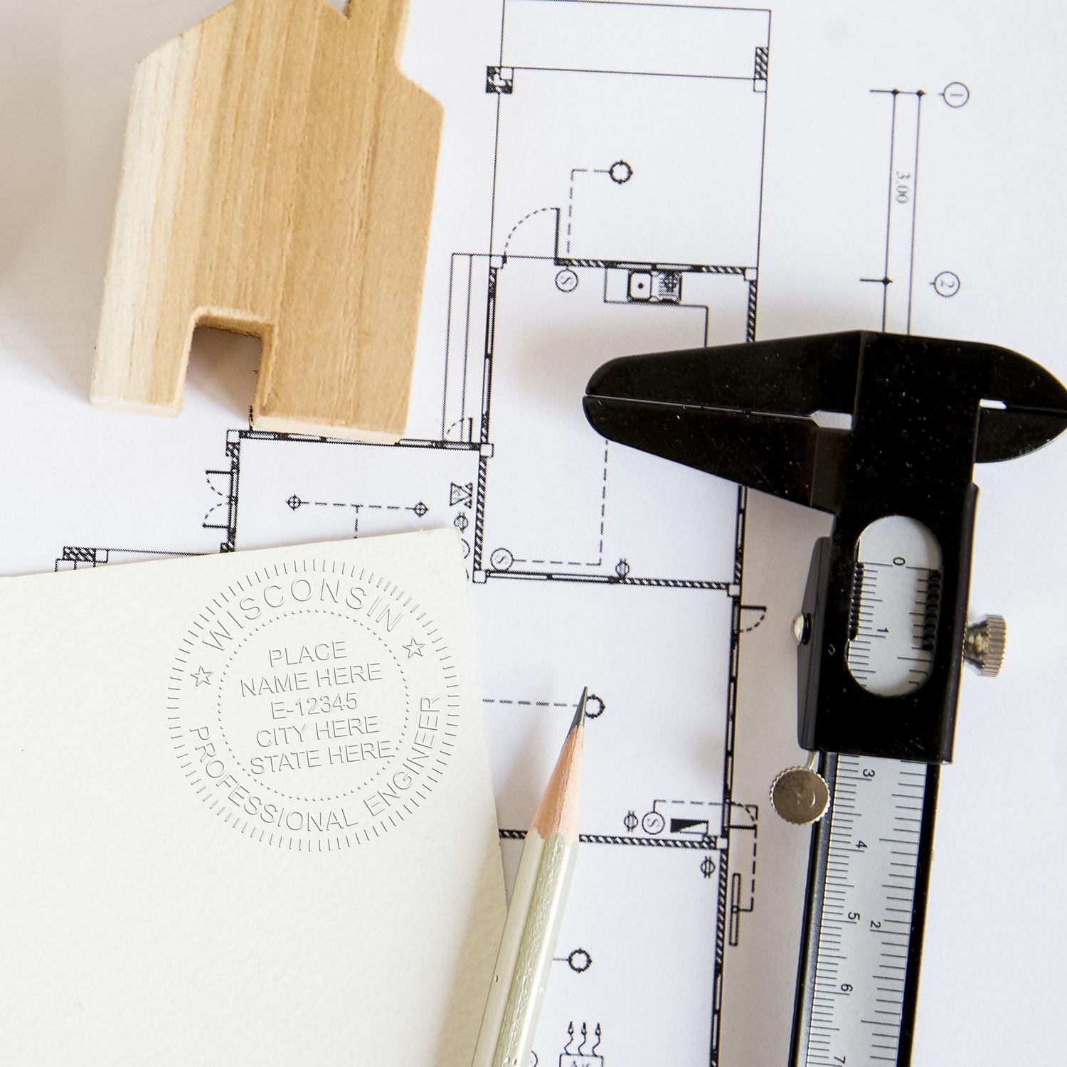 Wisconsin PE Embossers blog post: A Wisconsin professional engineer embosser seal, pencil, caliper, and house model on architectural plans.