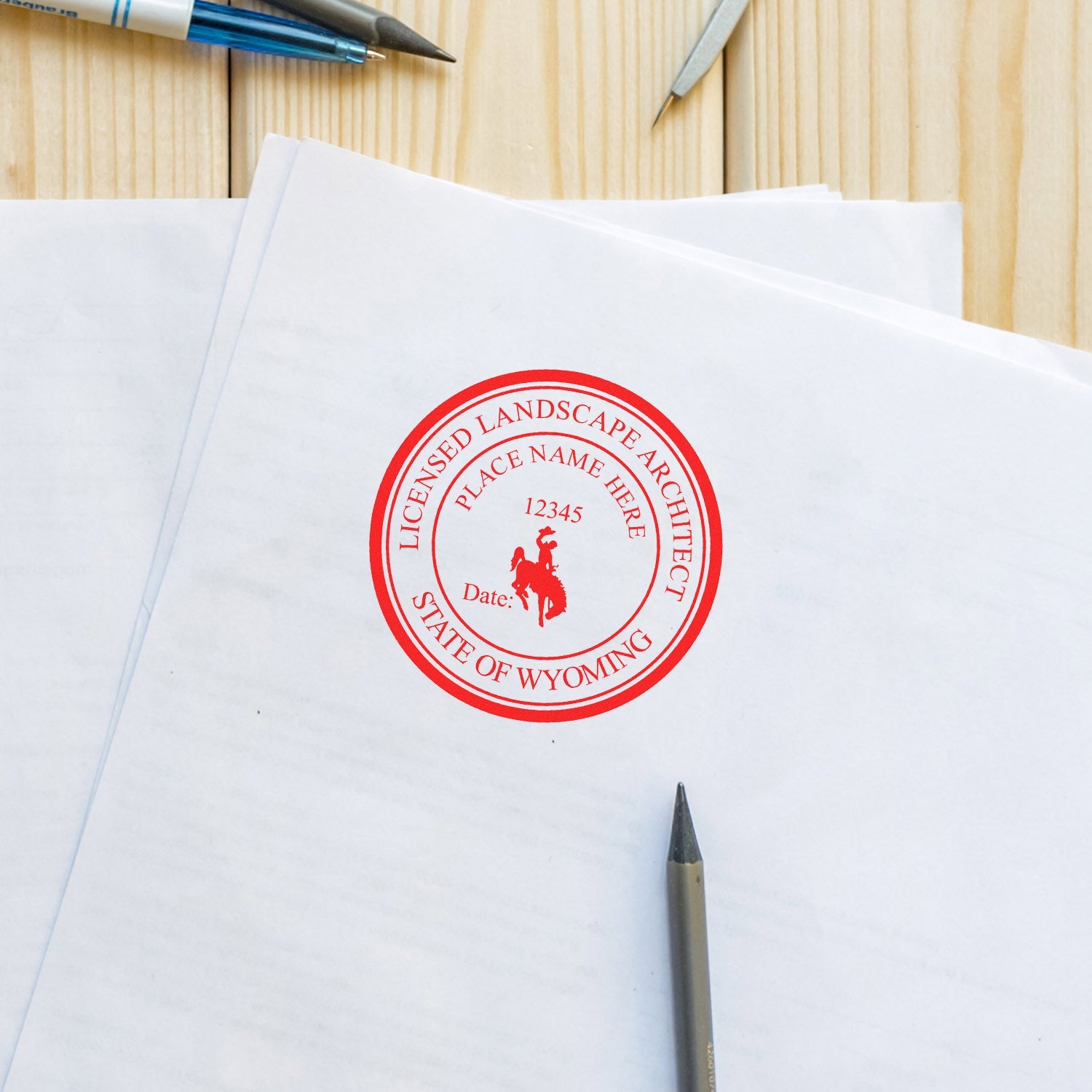 Wyoming Landscape Architect Feature Image: A red seal stamp on a document with a pen and pencil on a wooden desk.