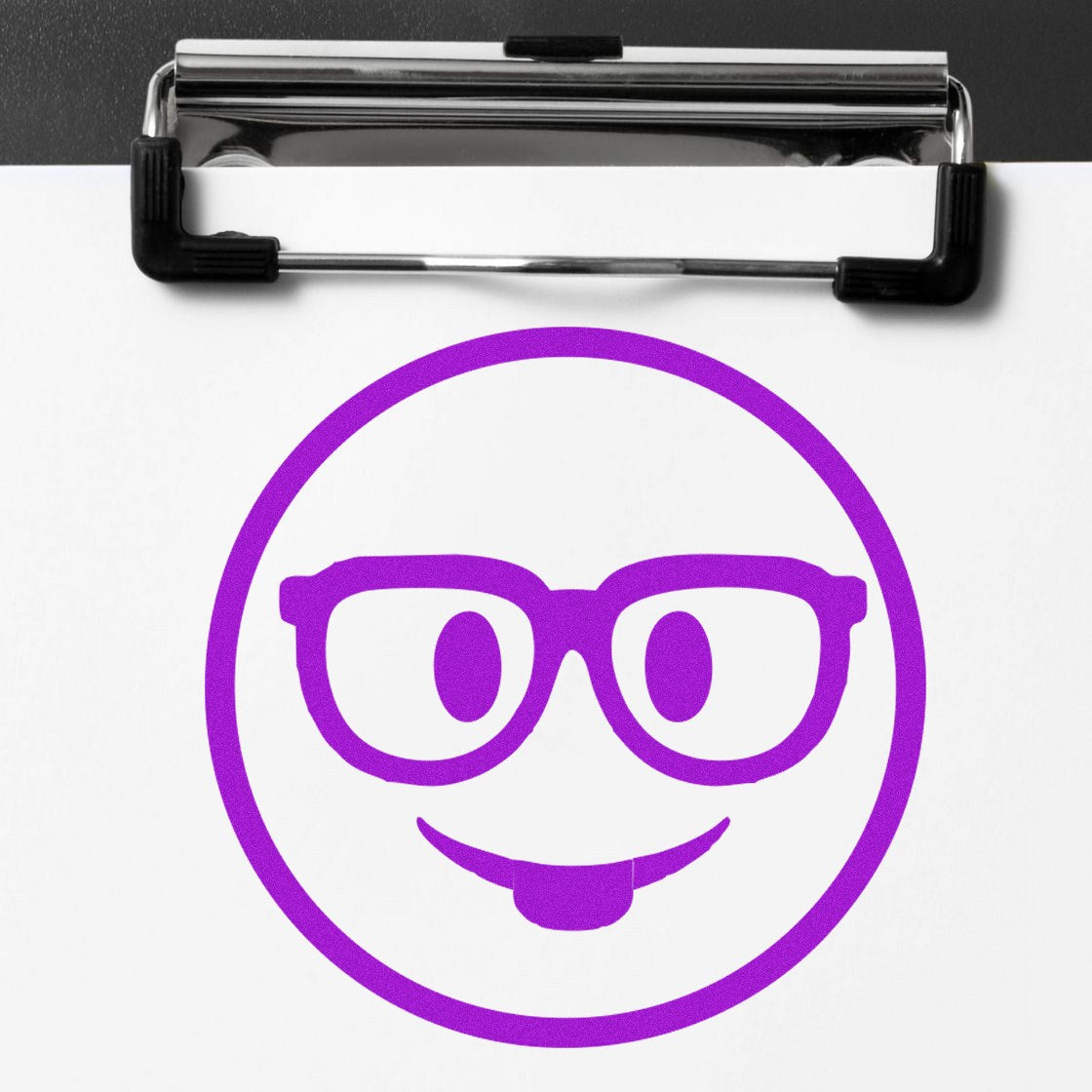 Self-Inking Smarty McGlasses Emotes Stamp featuring a purple smiley face with glasses and a playful tongue, stamped on white paper with a clipboard.