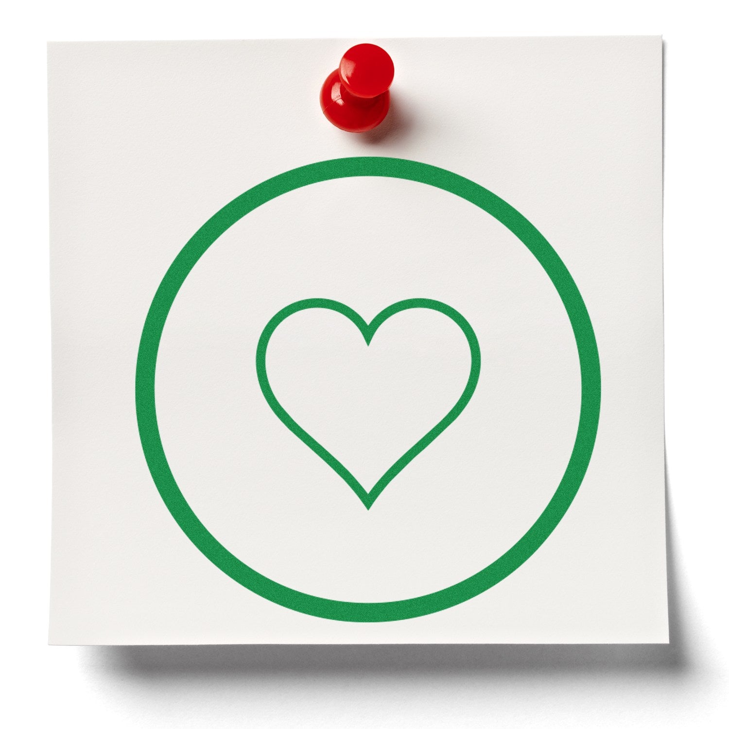 Self-Inking Heart of Simplicity Emojicons Stamp on white paper, featuring a green heart inside a circle, pinned with a red pushpin. Perfect for adding a touch of love to any project.