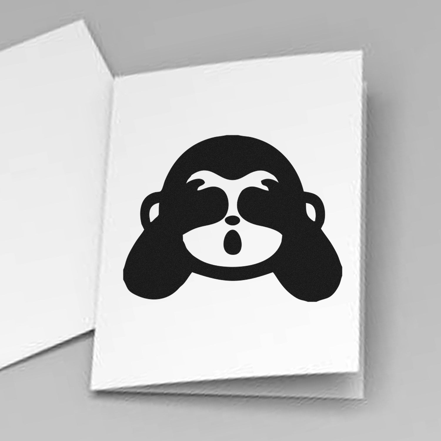 Wood Handle Blindfolded Monkey Emojicons Rubber Stamp on white paper, featuring a playful monkey emoji with hands over eyes. Perfect for adding fun, expressive designs to crafts and stationery.