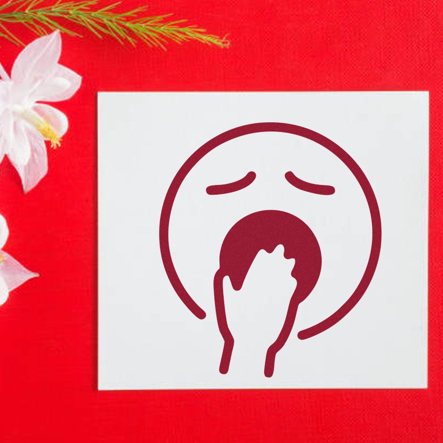 Self-Inking Yawning Yeti Emoji Stamp on red background, featuring a yawning face with hand over mouth. Perfect for adding a playful touch to stationery and crafts.