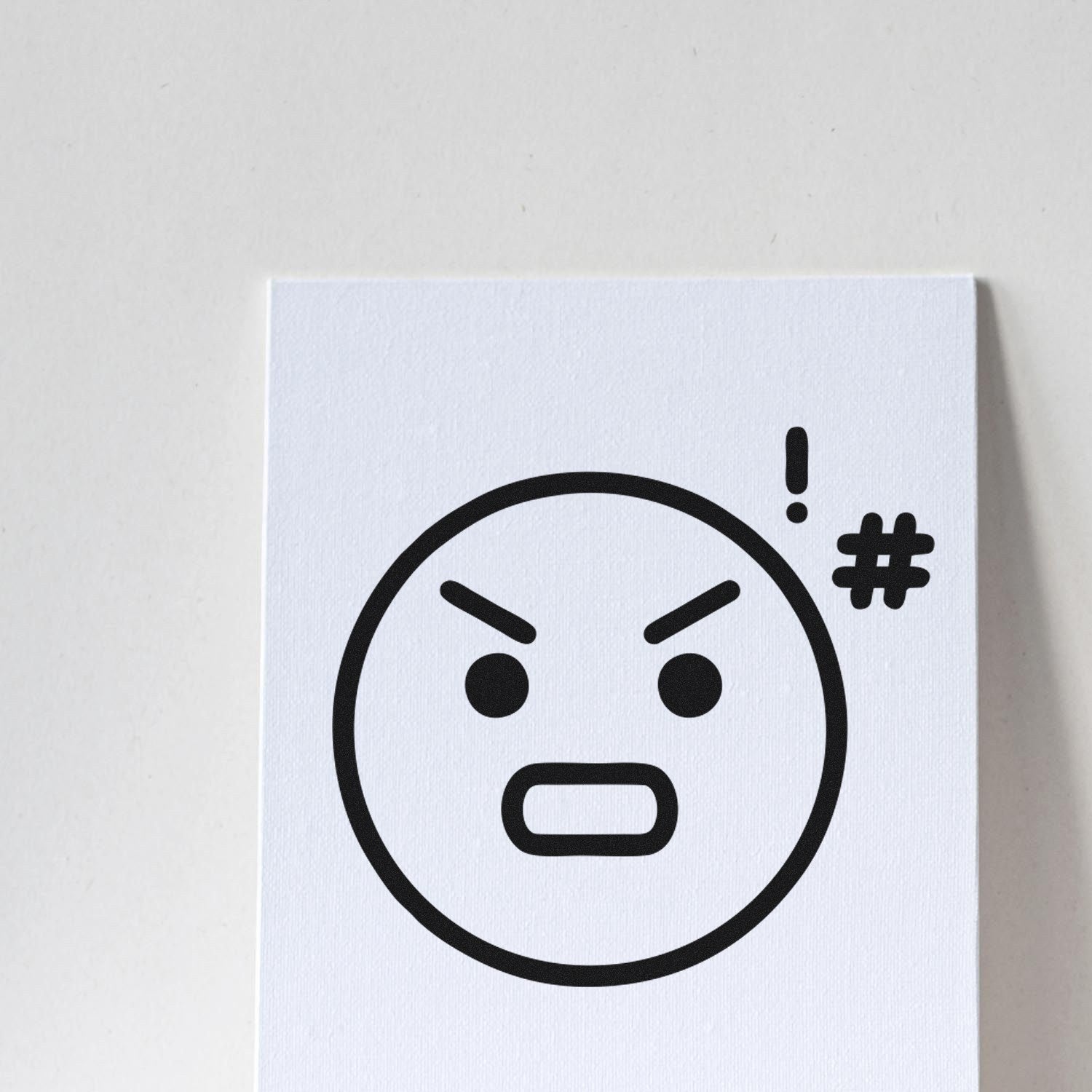 Wood Handle Angry Alfie Emoji Rubber Stamp featuring a bold, expressive angry face with furrowed brows and an exclamation mark. Perfect for adding personality to crafts and stationery.