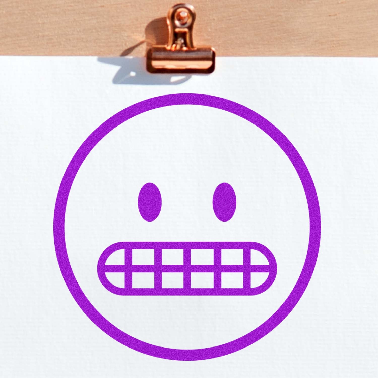 Wood Handle Awkward Alan Emoji Rubber Stamp featuring a purple awkward emoji face with gritted teeth, displayed on white paper with a wooden clip. Perfect for crafting and personalization.