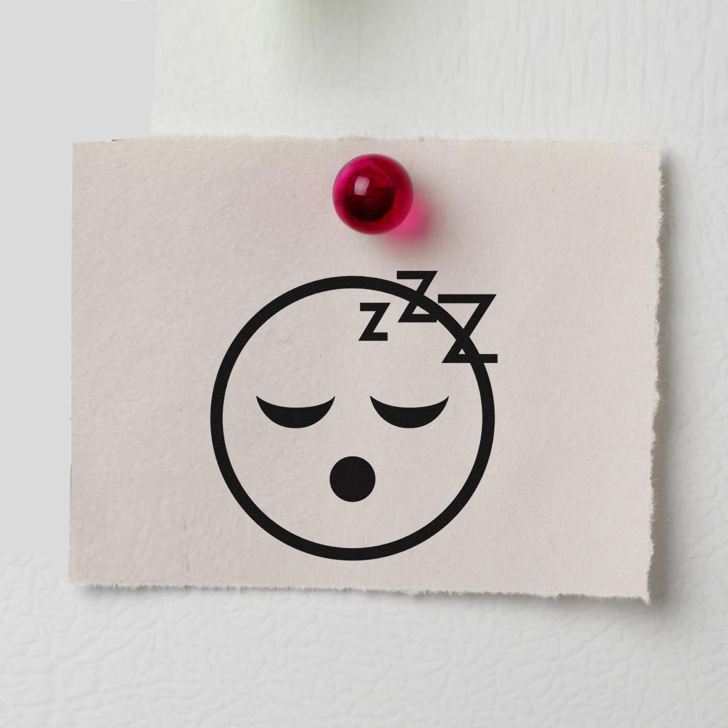 Image of the Wood Handle Sleepy Steve Reaction Rubber Stamp, featuring a sleepy face with closed eyes and Zzz above, stamped on paper. Perfect for adding a fun, sleepy touch to your projects.