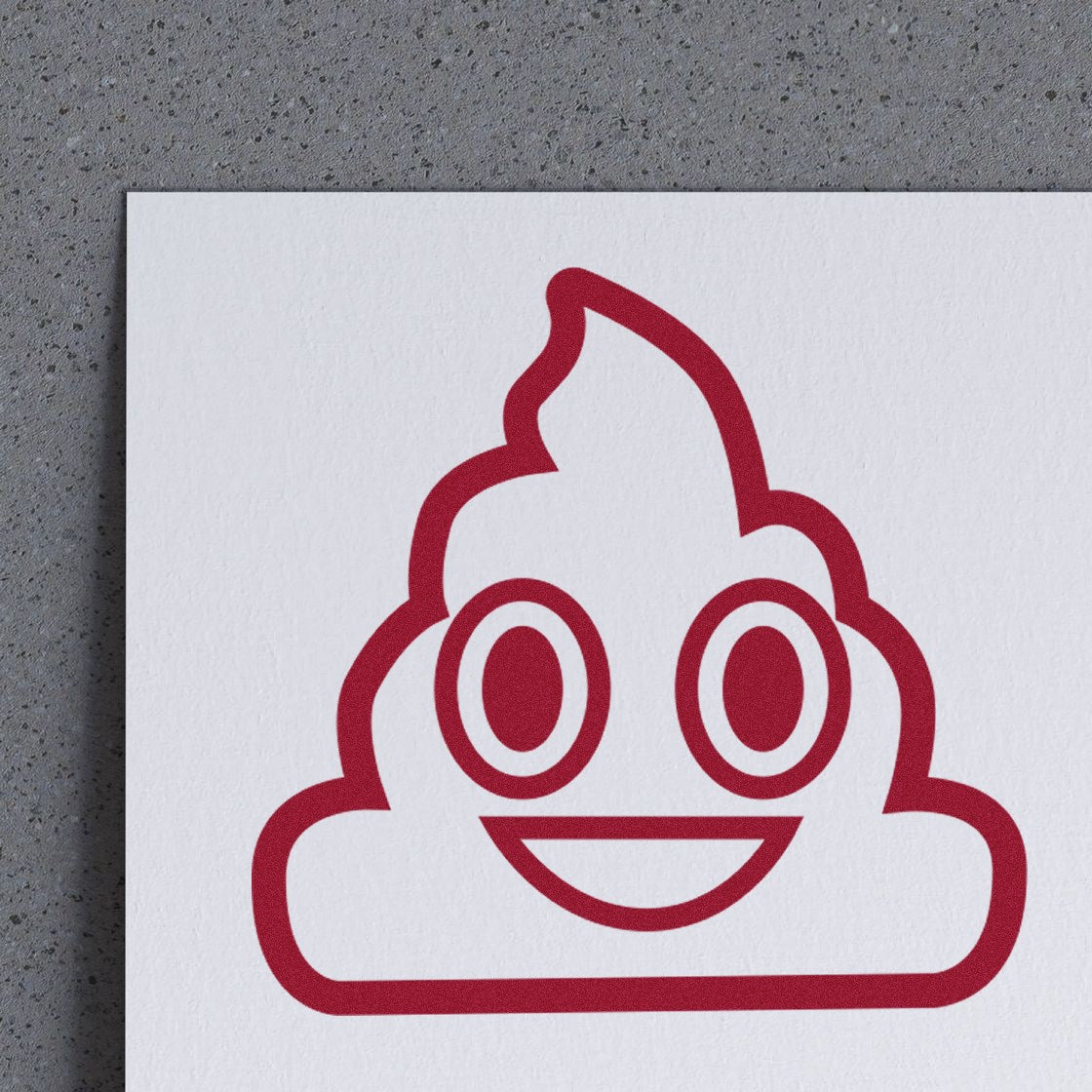 Image of a Self-Inking Smiling Poop Emojicons Stamp imprint on paper, featuring a cheerful poop emoji design in red ink. Perfect for adding fun to notes and crafts.