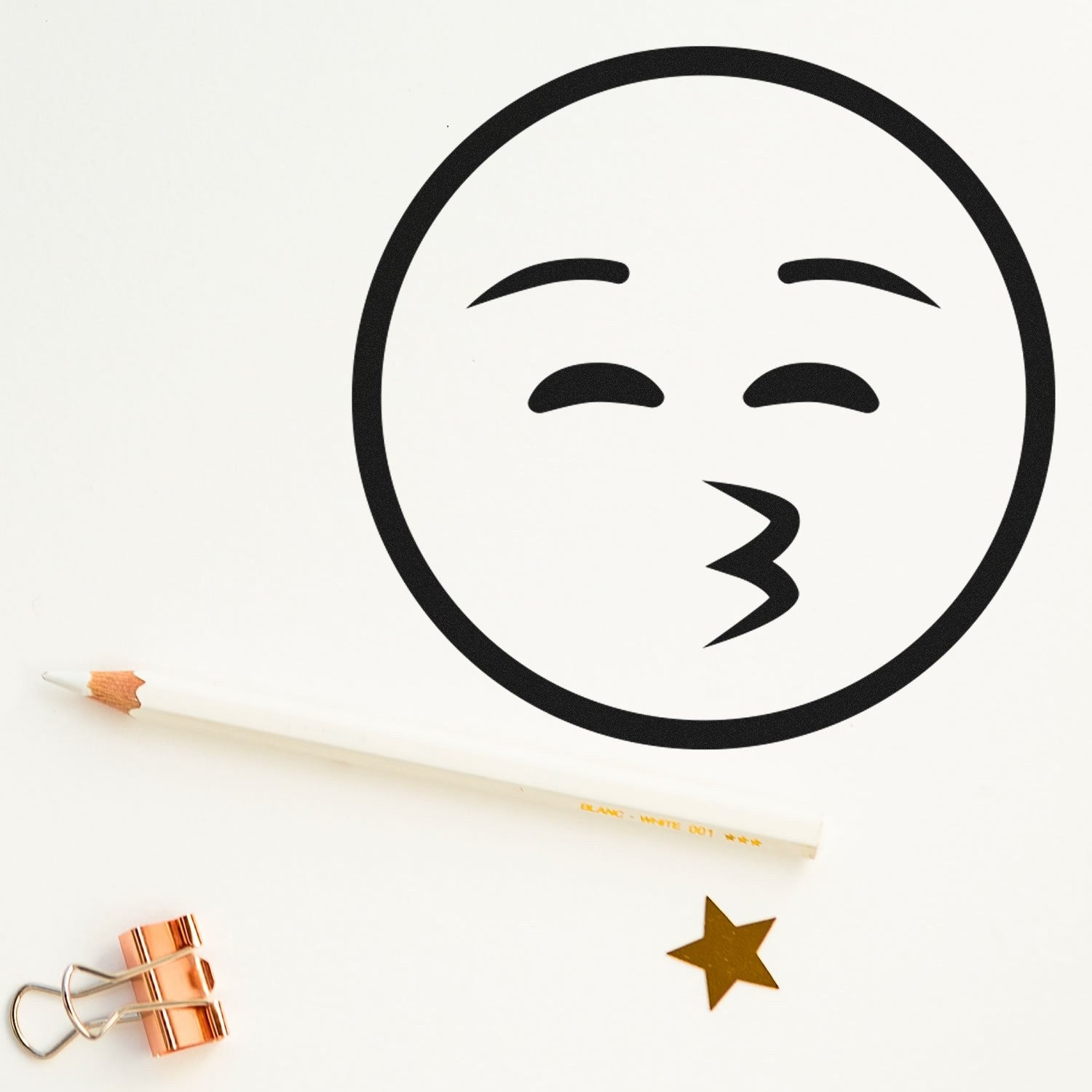 Wood Handle Whistling Wanderer Emoji Rubber Stamp on white paper, featuring a playful whistling face design. Includes a pencil, gold star, and copper clip for a creative touch.