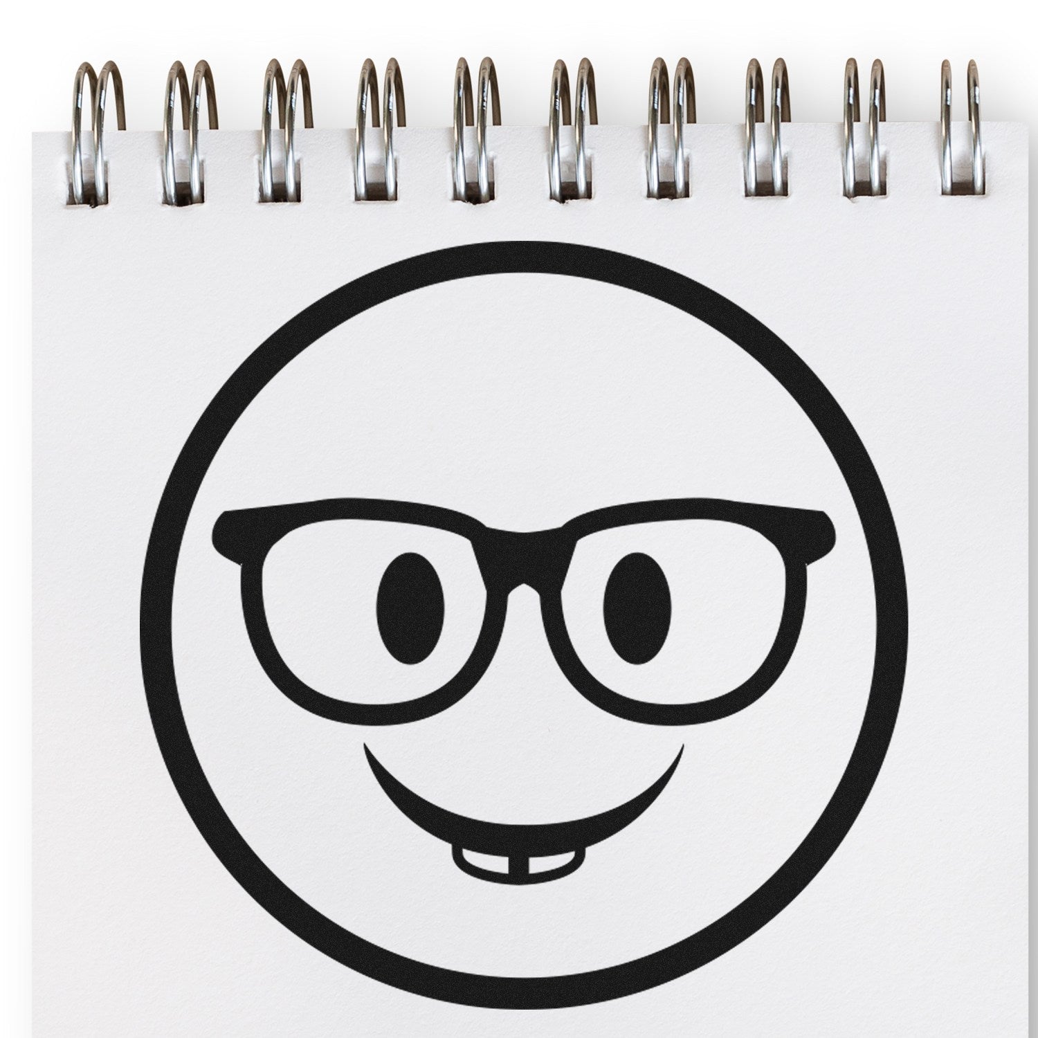 Self-Inking Wise Guy Smiley Stamp on notepad, featuring a smiling face with glasses and a toothy grin. Perfect for adding a fun touch to documents and crafts.