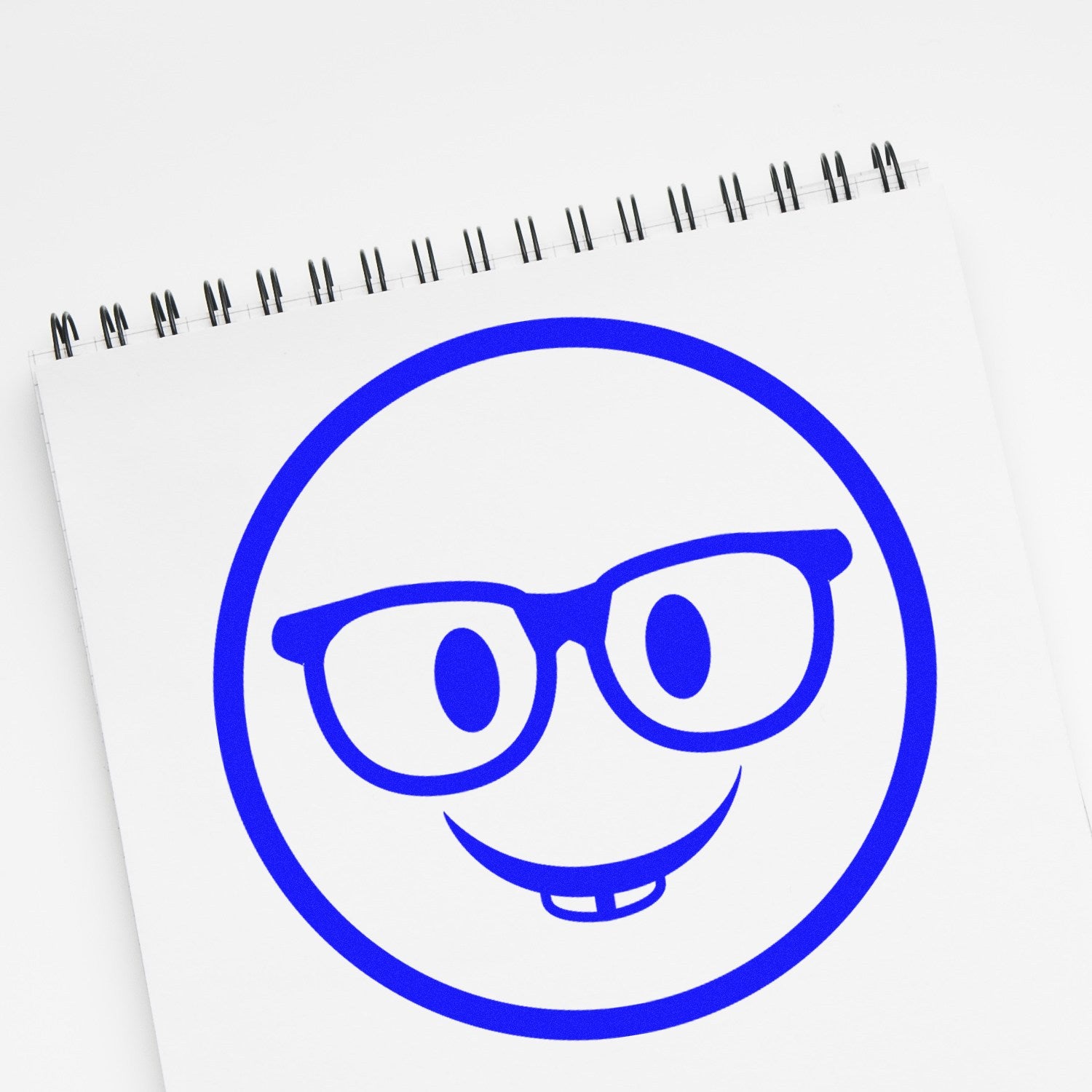 Wood Handle Wise Guy Smiley Rubber Stamp imprint on paper, featuring a blue smiley face with glasses and a toothy grin. Perfect for adding a playful touch to crafts and stationery.