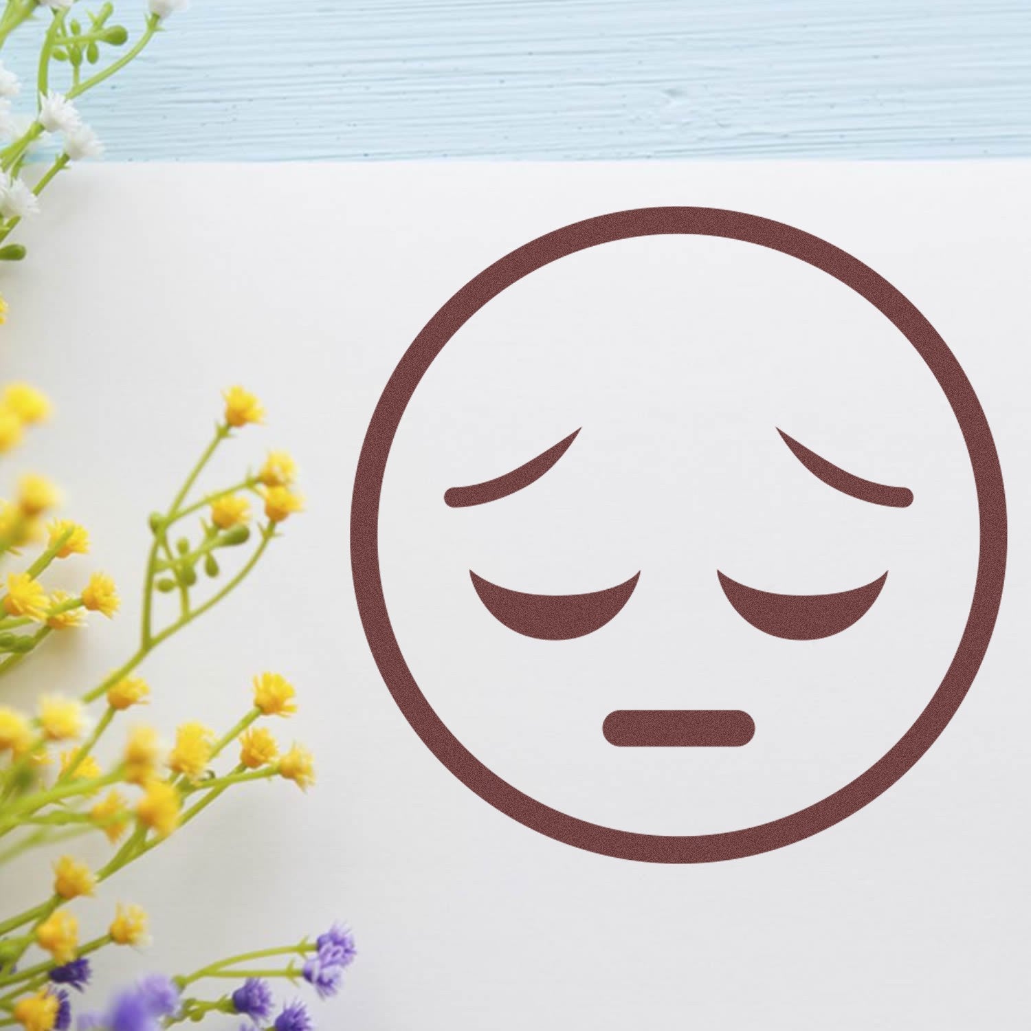 Self-Inking Silent Sorrow Emoji Stamp on paper, featuring a brown sad face design. Perfect for adding a touch of emotion to your stationery.