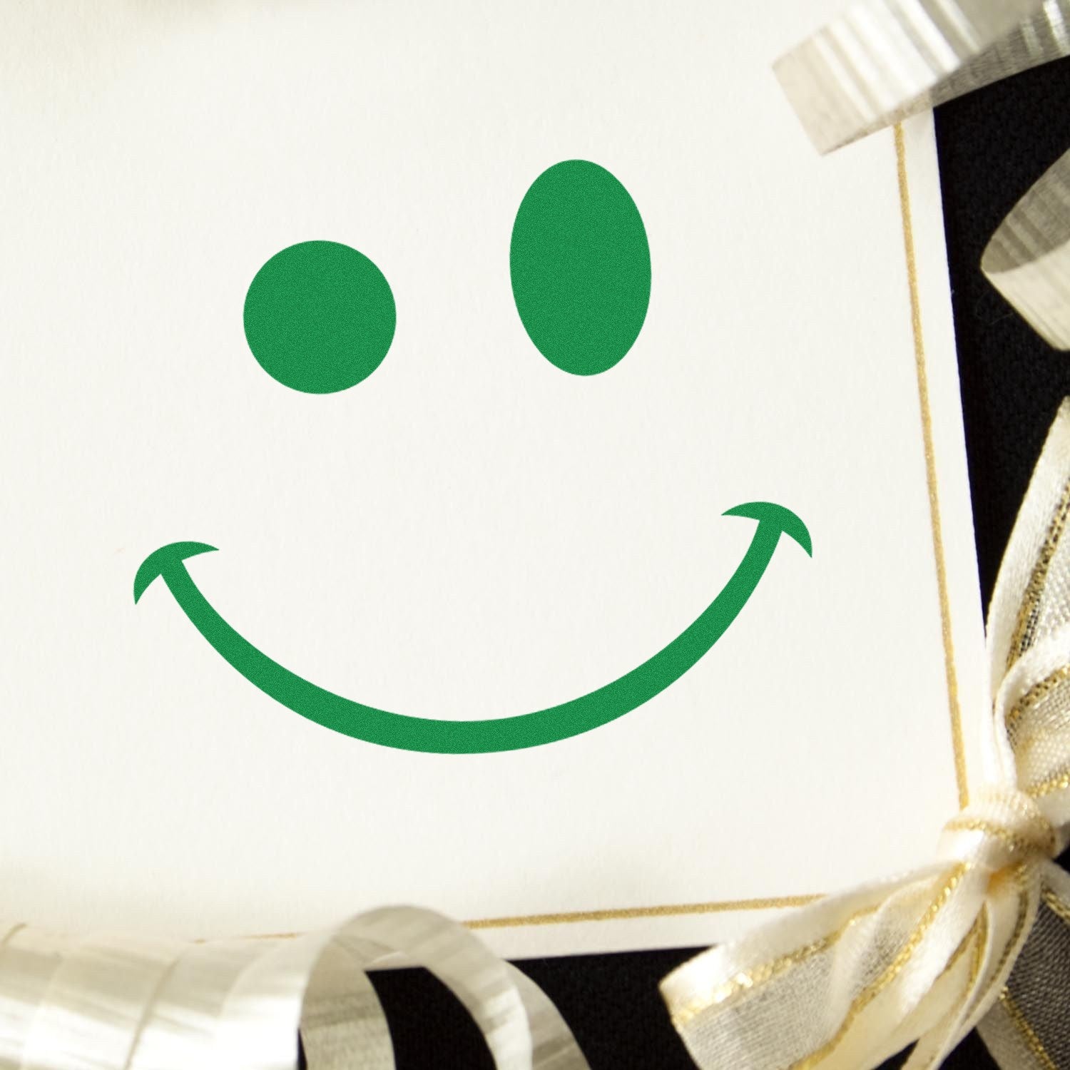 Self-Inking Mischievous Grin Emoji Stamp on white paper, featuring a playful green smiley face. Perfect for adding a fun touch to cards and crafts.