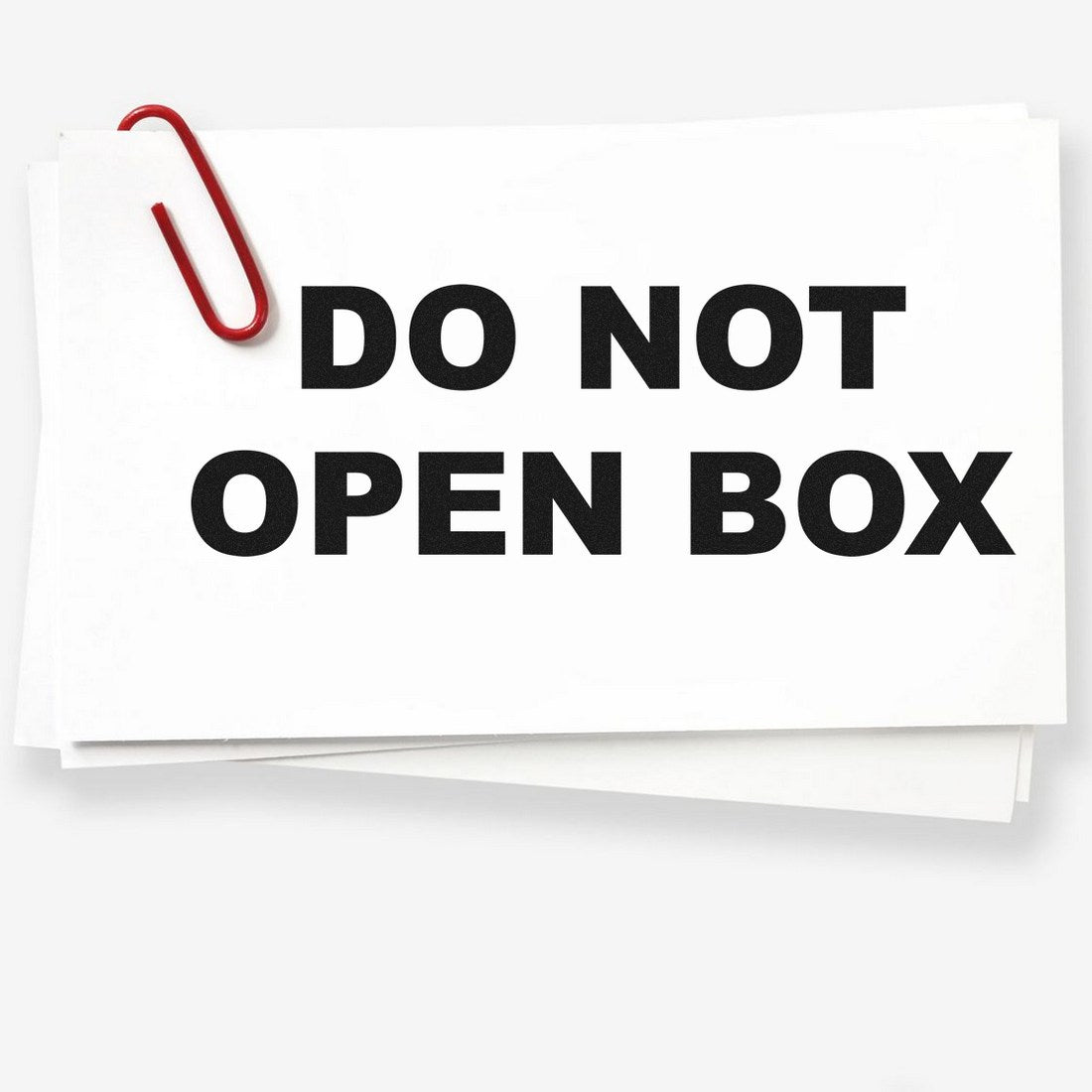 PSI Pre-Inked Do Not Open Box Stamp on white paper with a red paperclip, showcasing bold black text. Ideal for secure packaging and shipping needs.