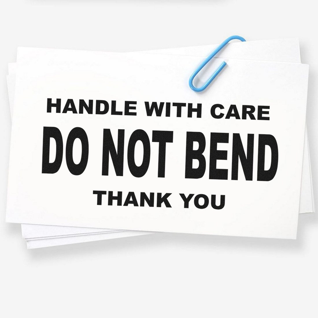 Image of a Slim Pre-Inked Handle With Care Do Not Bend Thank You Stamp, featuring bold black text on a white background, ideal for marking packages.