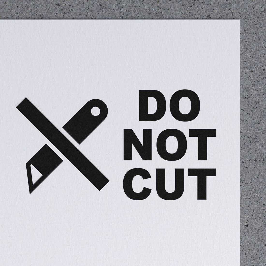 PSI Pre-Inked Do Not Cut Symbol Stamp on white paper, featuring a bold black graphic of a crossed-out utility knife and the text DO NOT CUT in clear, uppercase letters.