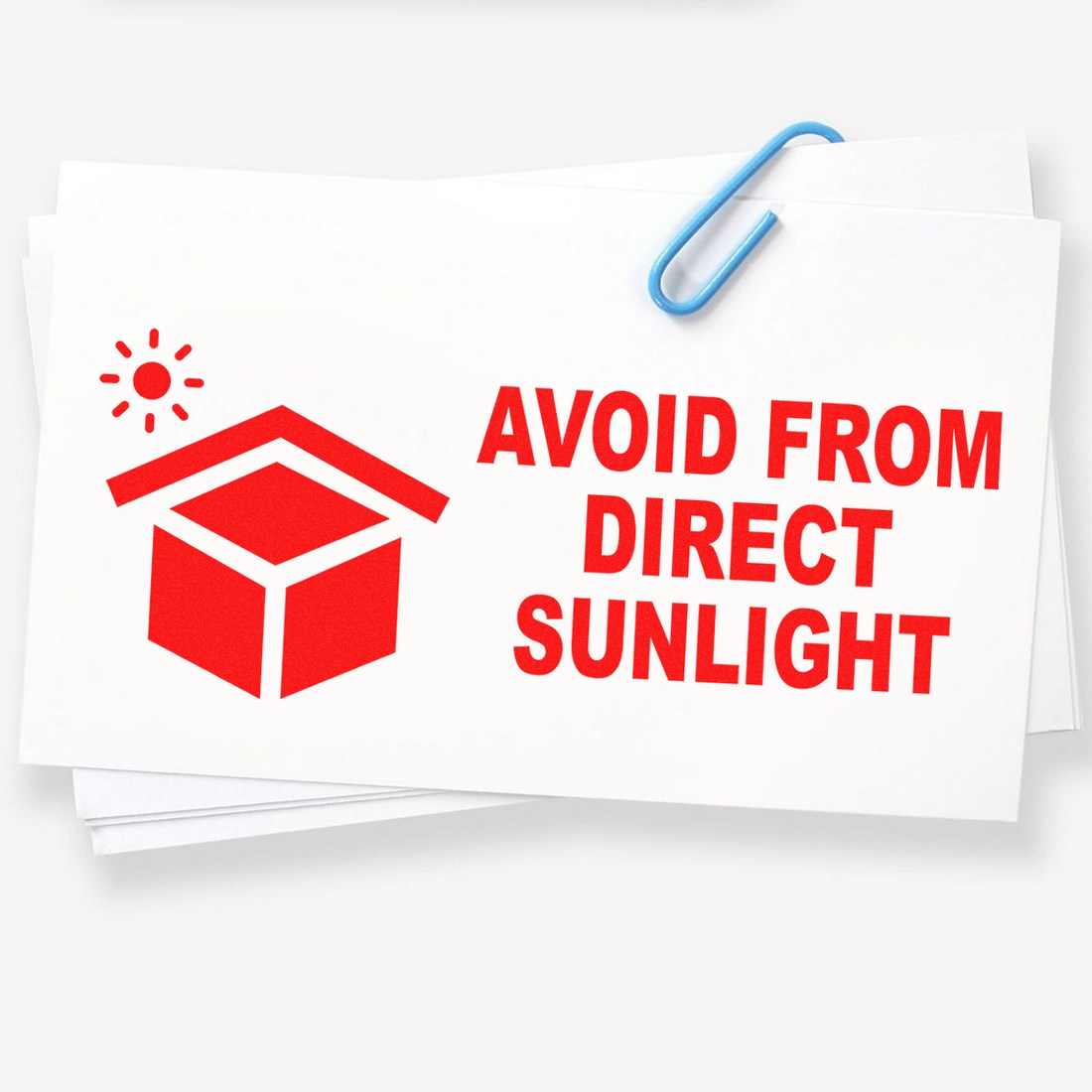 Image of a Wood Handle Sunlight Protection Warning Rubber Stamp featuring a red icon of a box with a sun and the text Avoid from Direct Sunlight on white paper, secured with a paperclip.