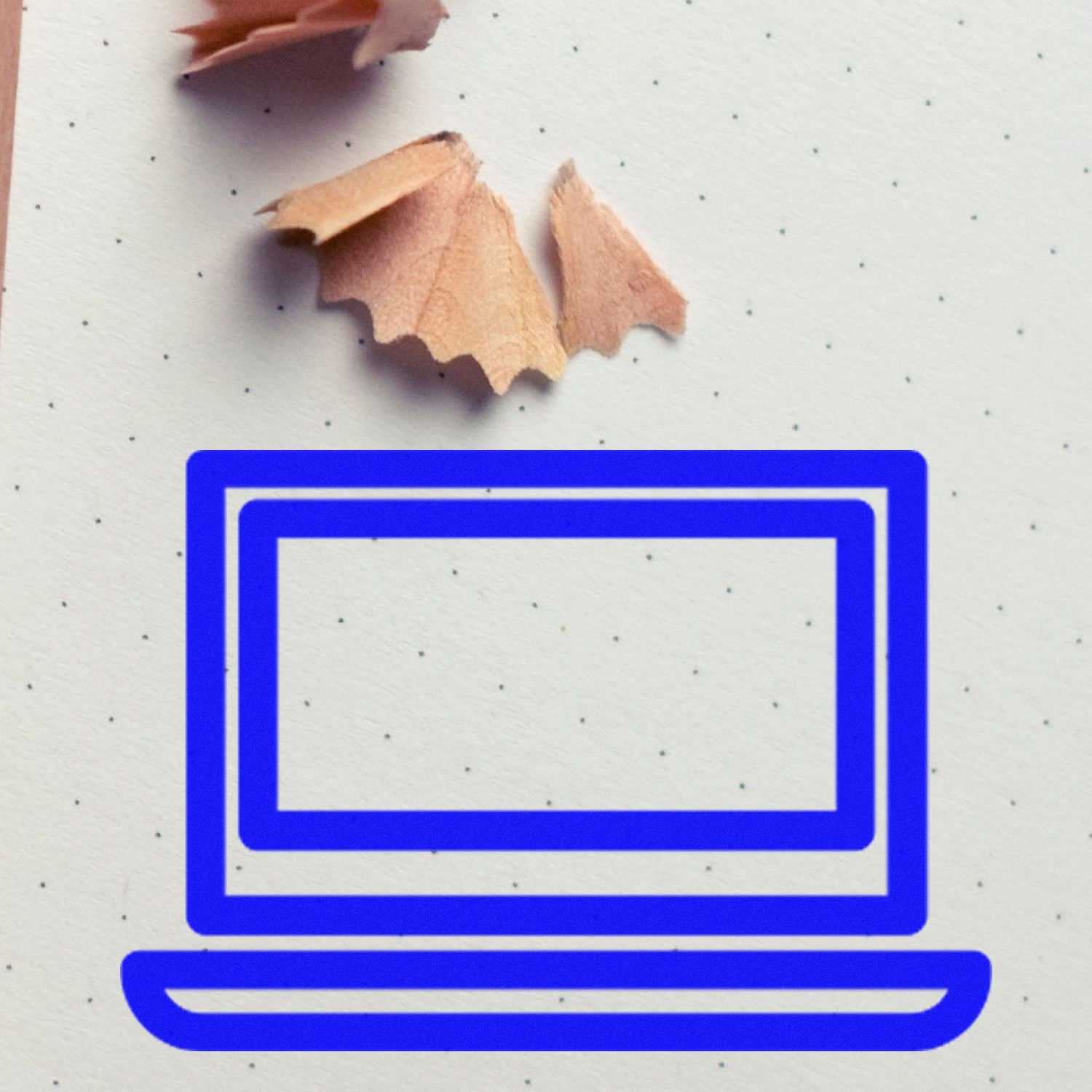 Wood Handle Techie Punch Card Rubber Stamp on dotted paper with pencil shavings, featuring a blue laptop design. Ideal for tech-themed crafts and stationery.