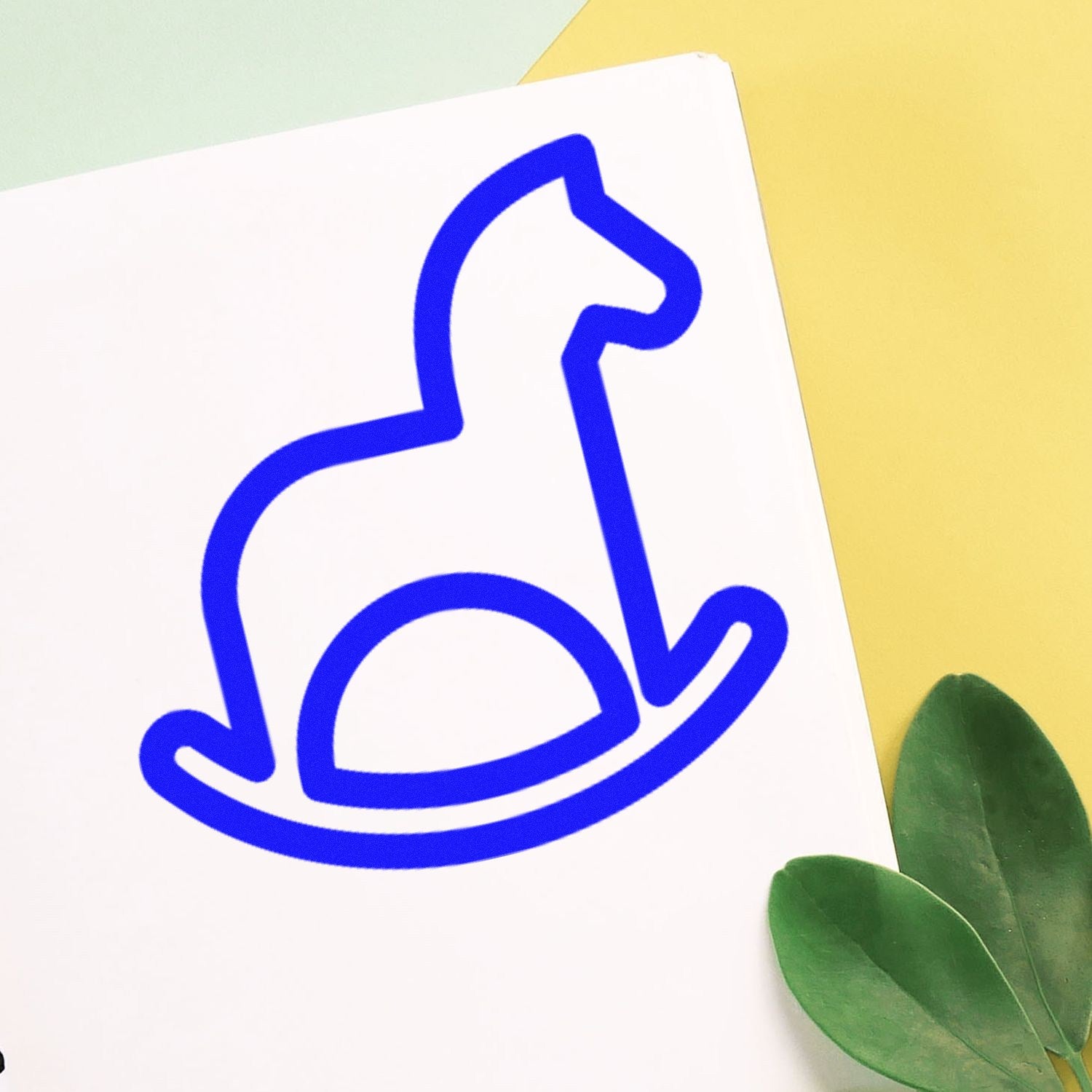 Wood Handle Rocking Horse Delight Loyalty Scheme Rubber Stamp with a blue horse outline on white paper, set against a pastel background.