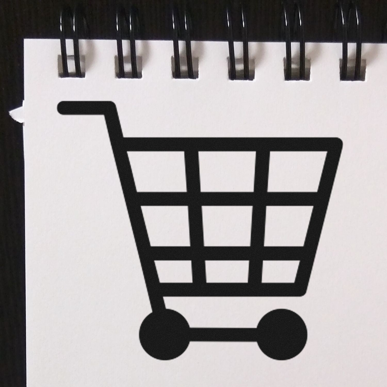 Self-Inking Shopper's Delight Discount Stamp featuring a black shopping cart icon on a white background, ideal for marking discounts and promotions efficiently.