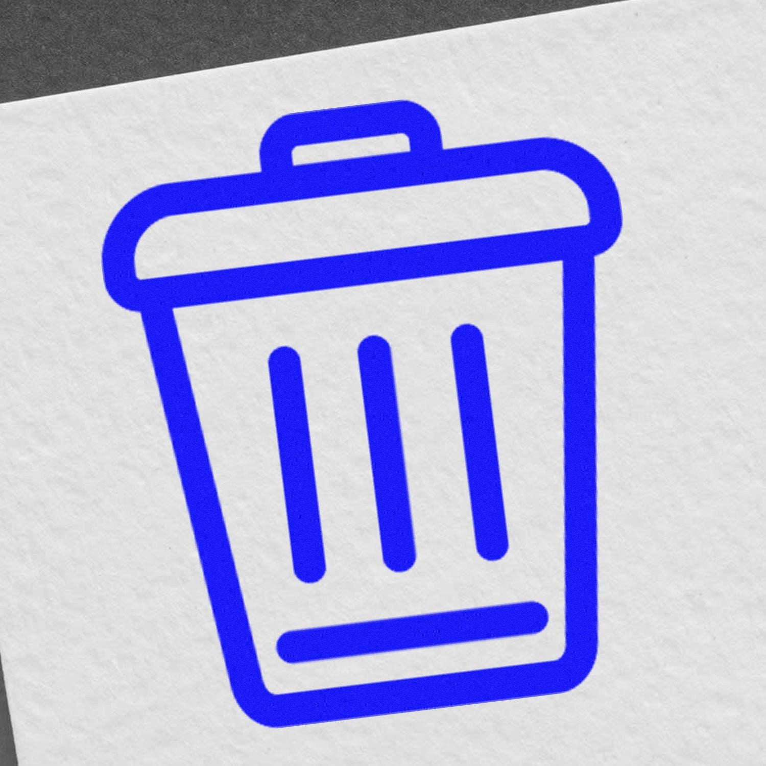 Self-Inking Clean World-Based Rewards Stamp with blue trash bin design on white paper, ideal for eco-friendly educational use.