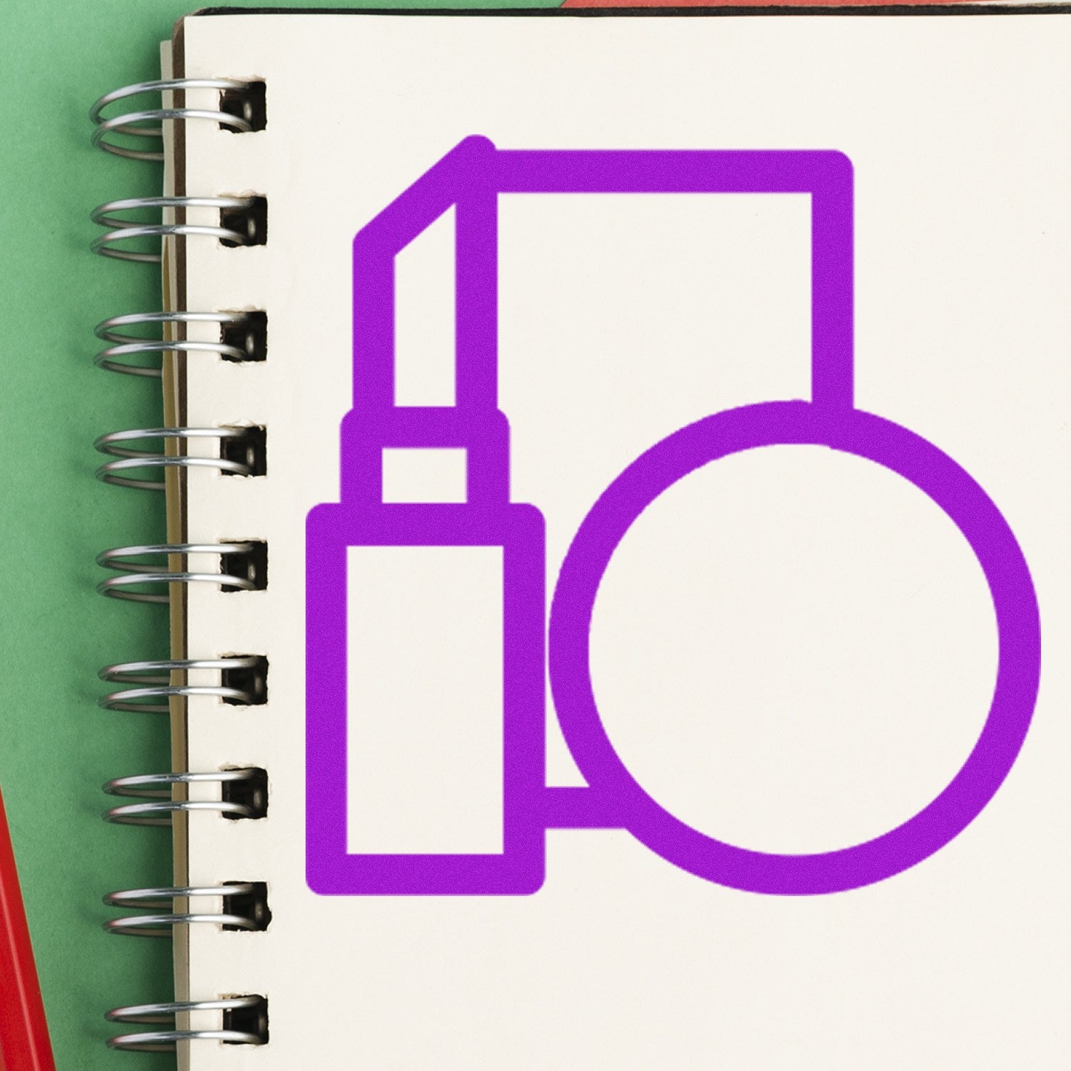 Image of the Self-Inking Beauty Bonus Stamp on a spiral notebook. The stamp features a purple design with a lipstick and compact mirror icon, ideal for beauty-themed projects.