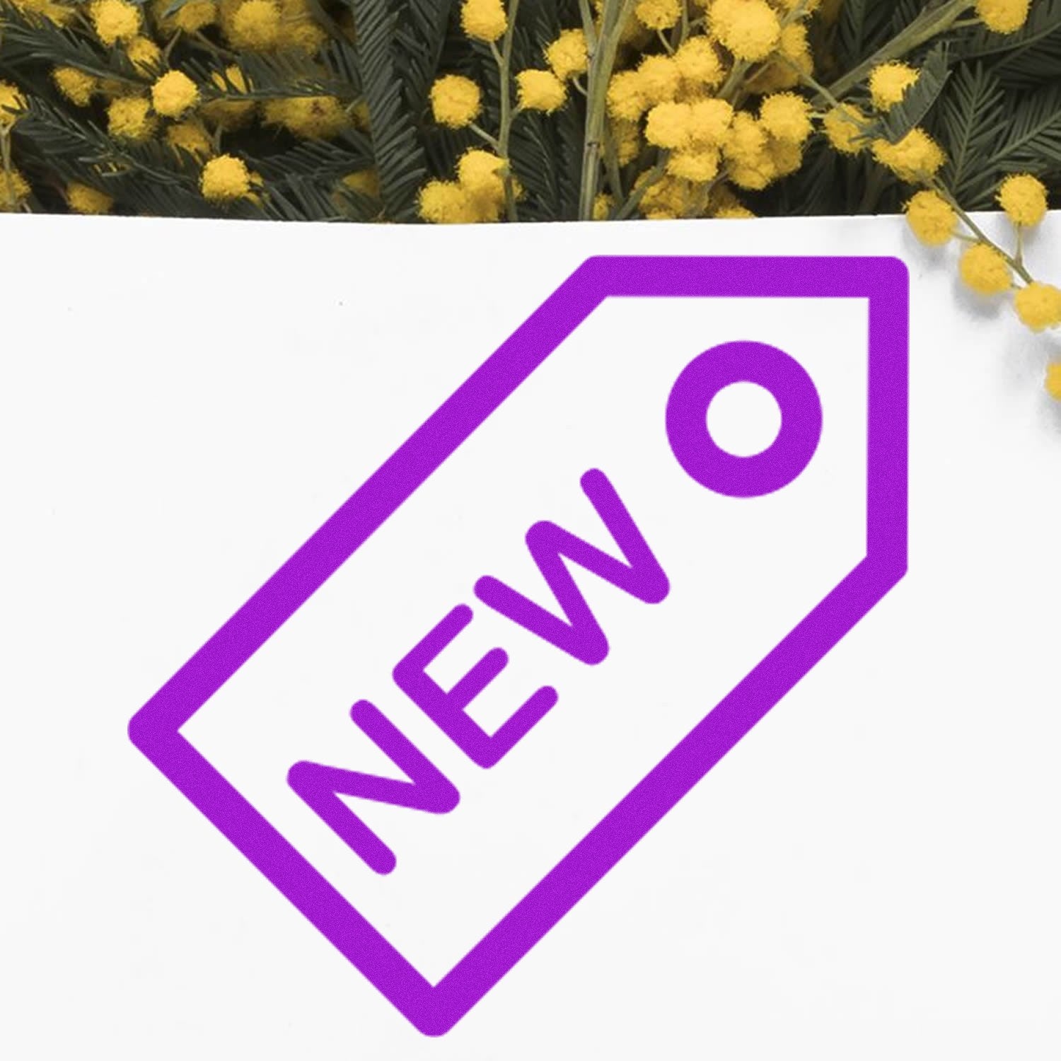 Self-Inking New Reward Stamp with purple 'NEW' tag design on white paper, surrounded by yellow flowers. Ideal for teachers and businesses.