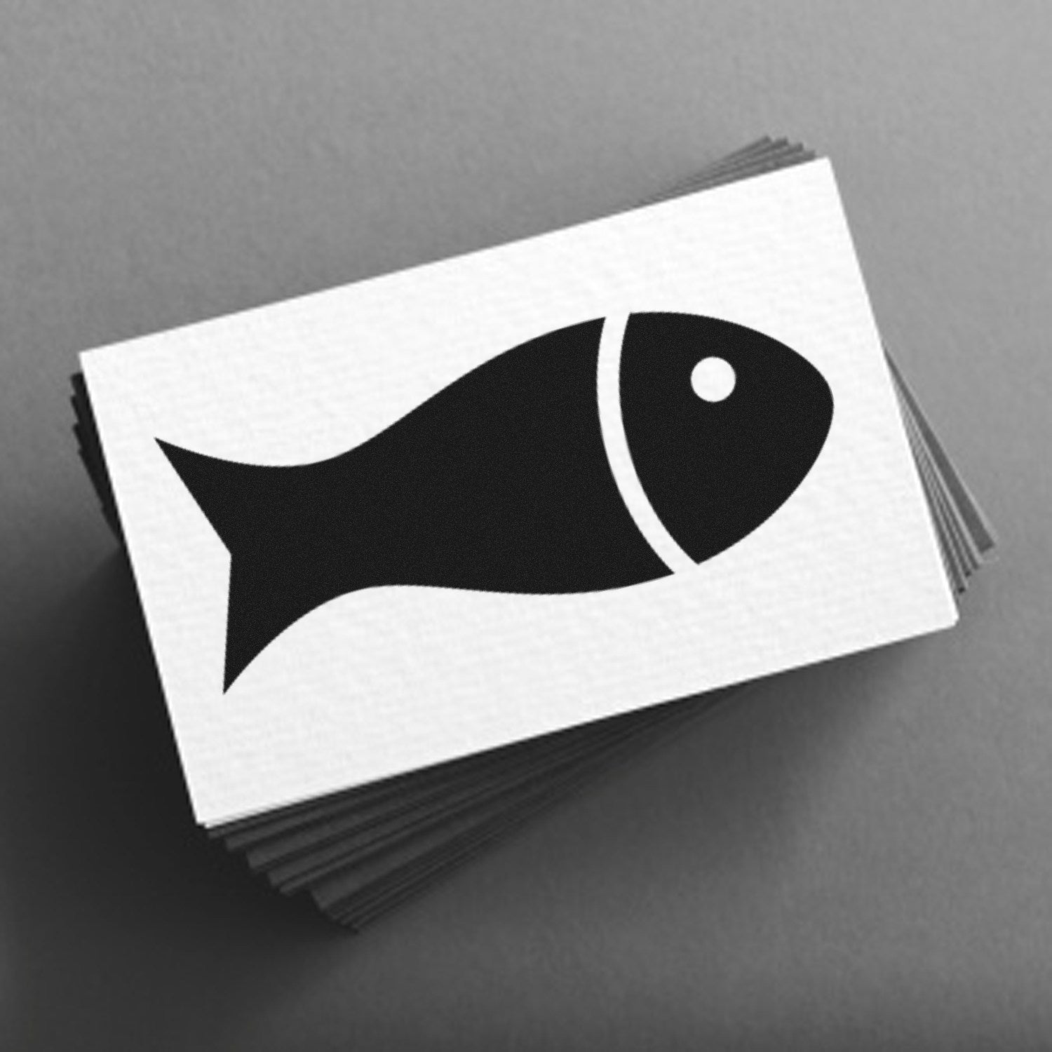 Image of the Self-Inking Fin-Tastic Loyalty Incentive Stamp, featuring a black fish design on a stack of white cards, perfect for rewarding customer loyalty.