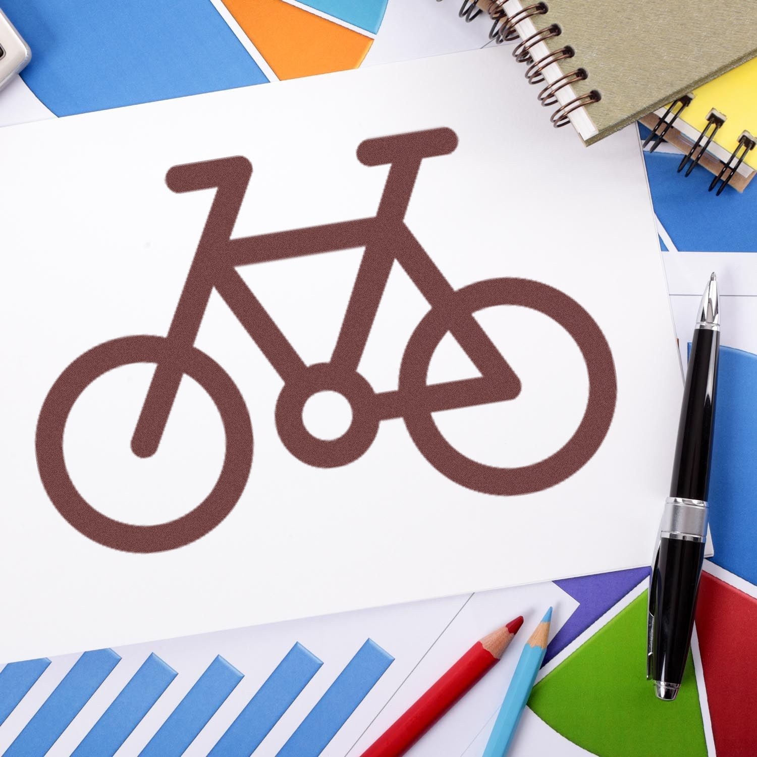 Wood Handle Cycle Of Loyalty Rubber Stamp on paper, featuring a bicycle design. Surrounded by colorful stationery, showcasing its use in creative projects.