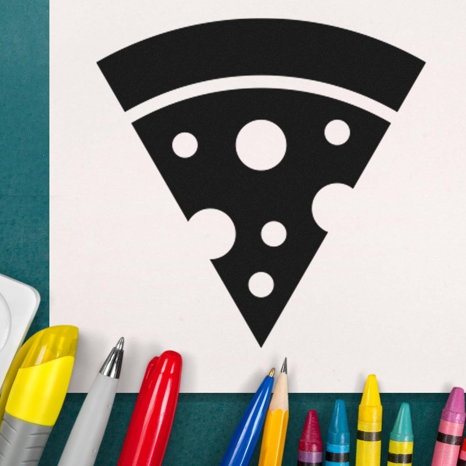 Self-Inking Pizza Perks Incentive Stamp featuring a black pizza slice design on white paper, surrounded by colorful pens and crayons on a green surface.