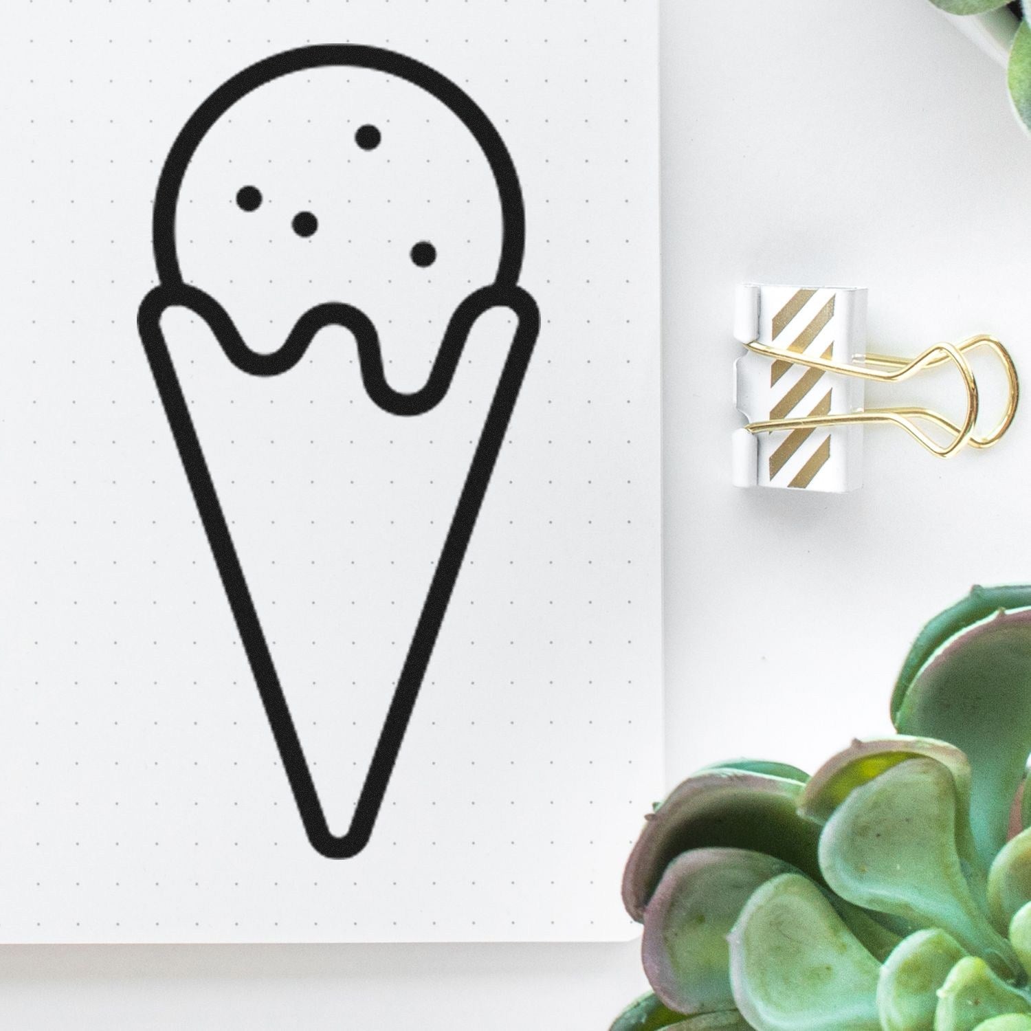 Wood Handle Sweet Rewards Purchase Rubber Stamp featuring an ice cream cone design, displayed on dotted paper with a gold binder clip and green succulents nearby.