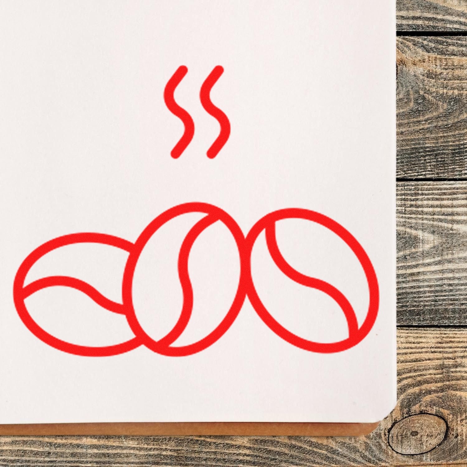 Wood Handle Bean Loyalty Scheme Rubber Stamp on wooden surface, featuring a red coffee bean design with steam lines, ideal for marking loyalty cards.