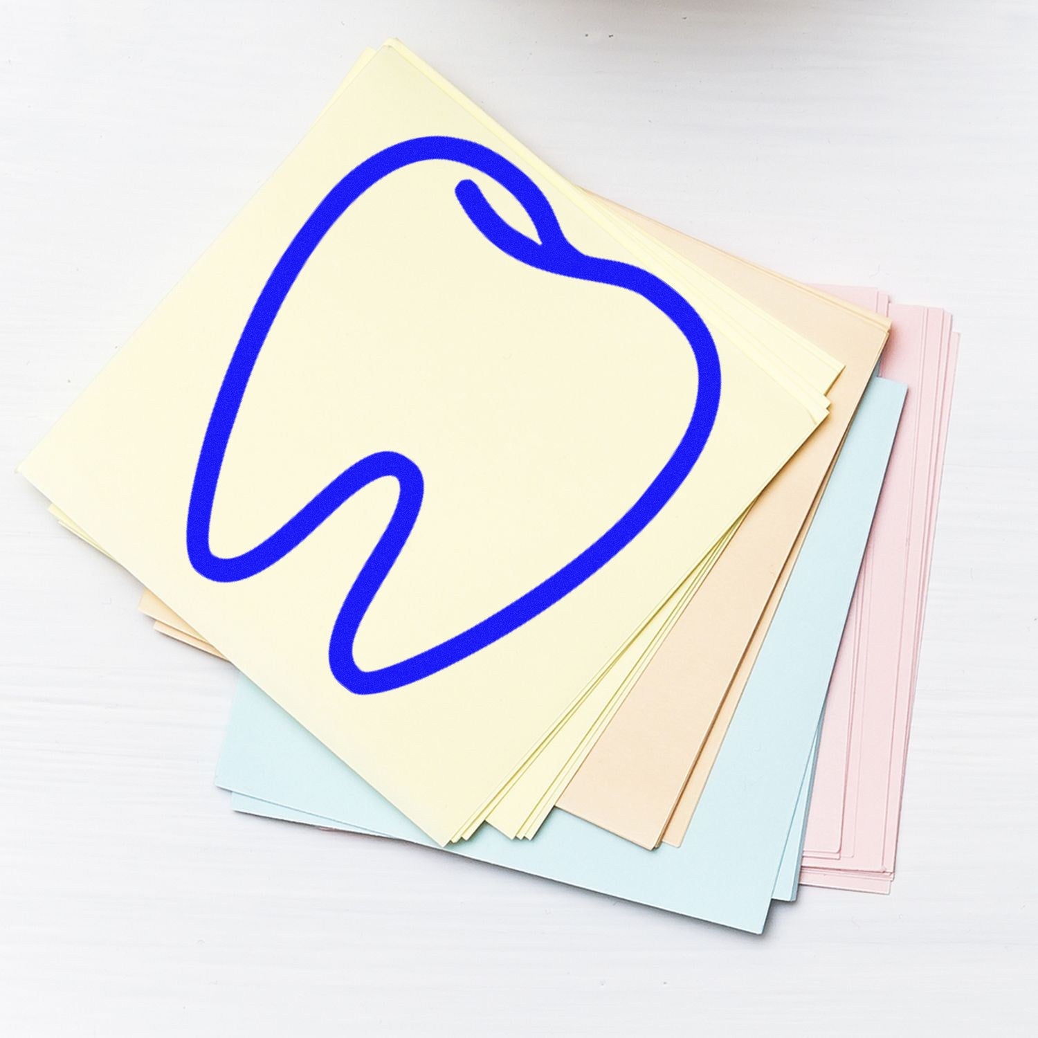 Wood Handle Dental Visit Rubber Stamp with a tooth design, featuring a sturdy wooden handle and rubber stamp base, ideal for dental office use. Image shows stamp on pastel papers.