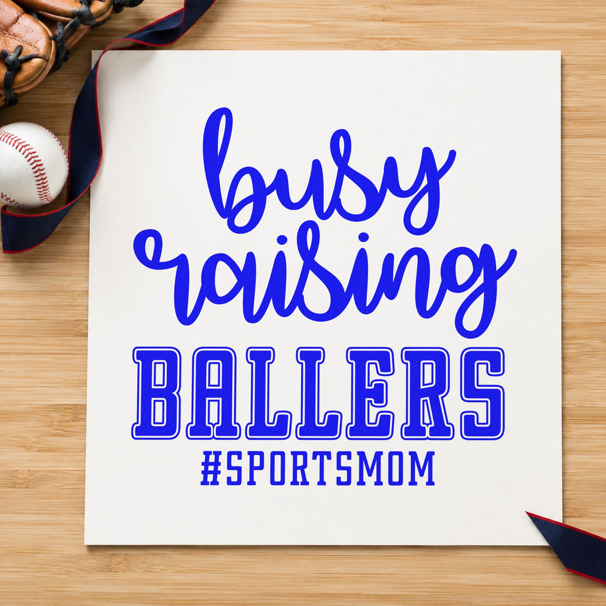 Busy Raising Ballers craft stamp imprinted in blue ink on paper, a design suited to planner weekend pages.