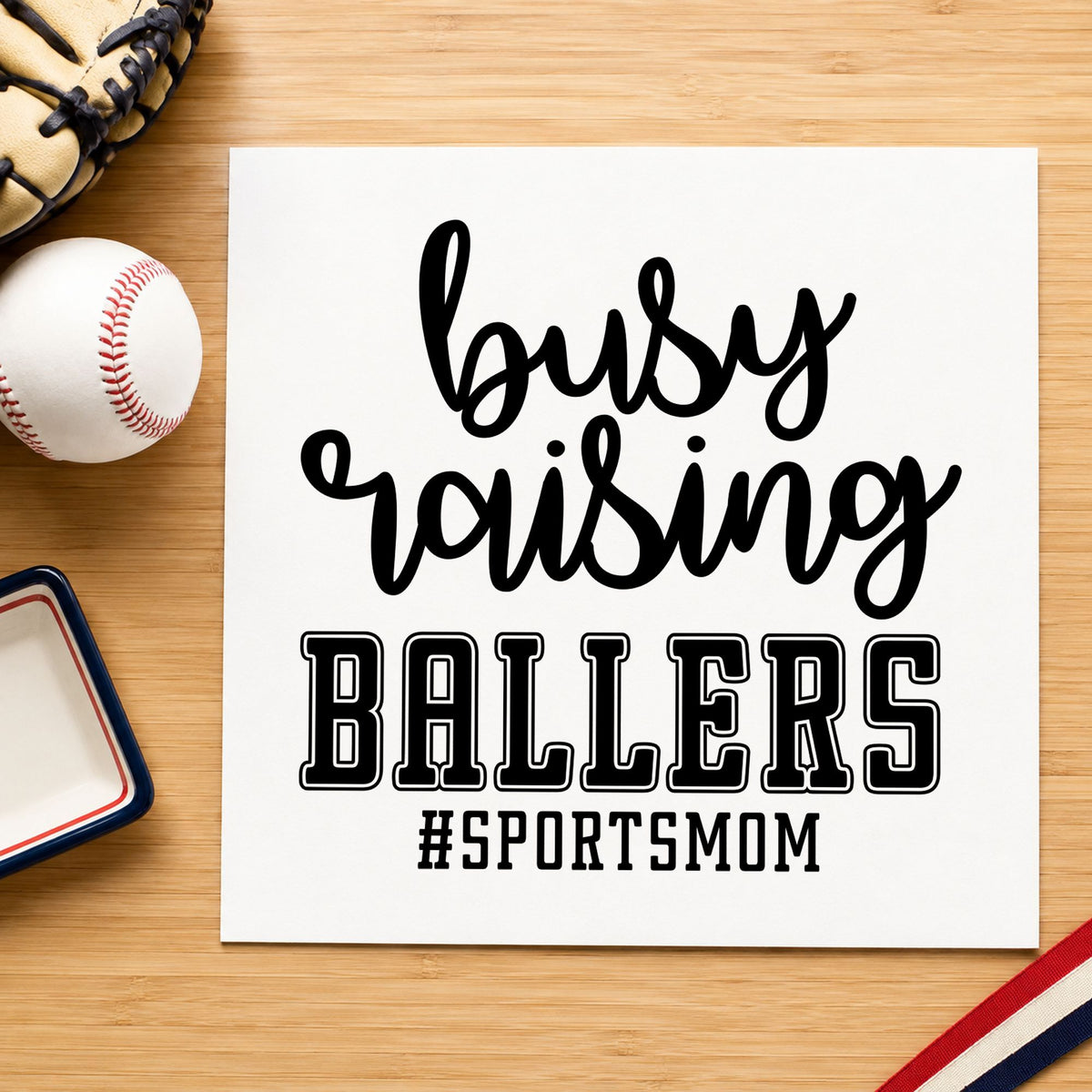 Busy Raising Ballers rubber stamp printed in black ink, ready for sports mom birthdays and similar paper crafts.