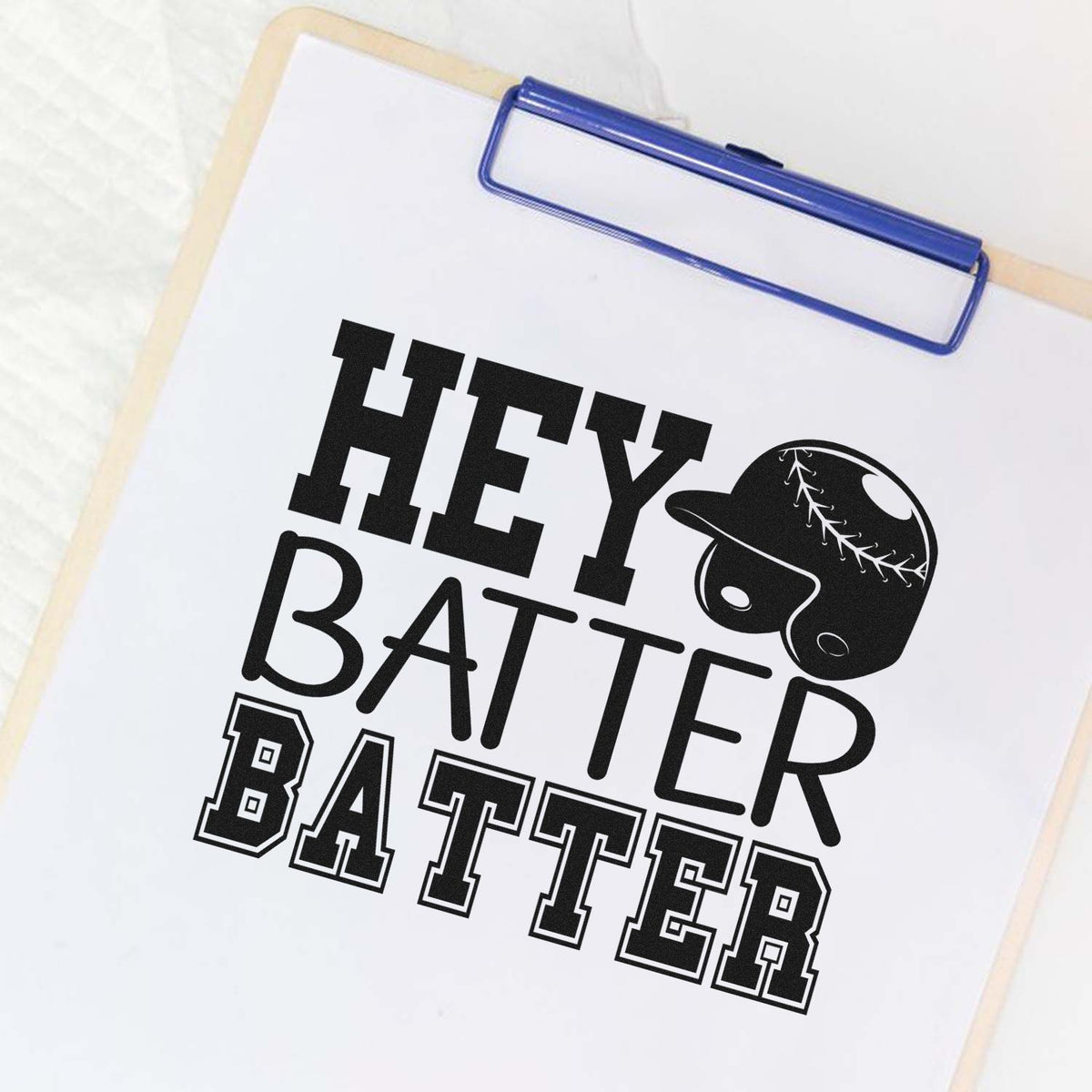 Custom stamp and seal on clipboard with black HEY BATTER BATTER baseball design and blue clip.
