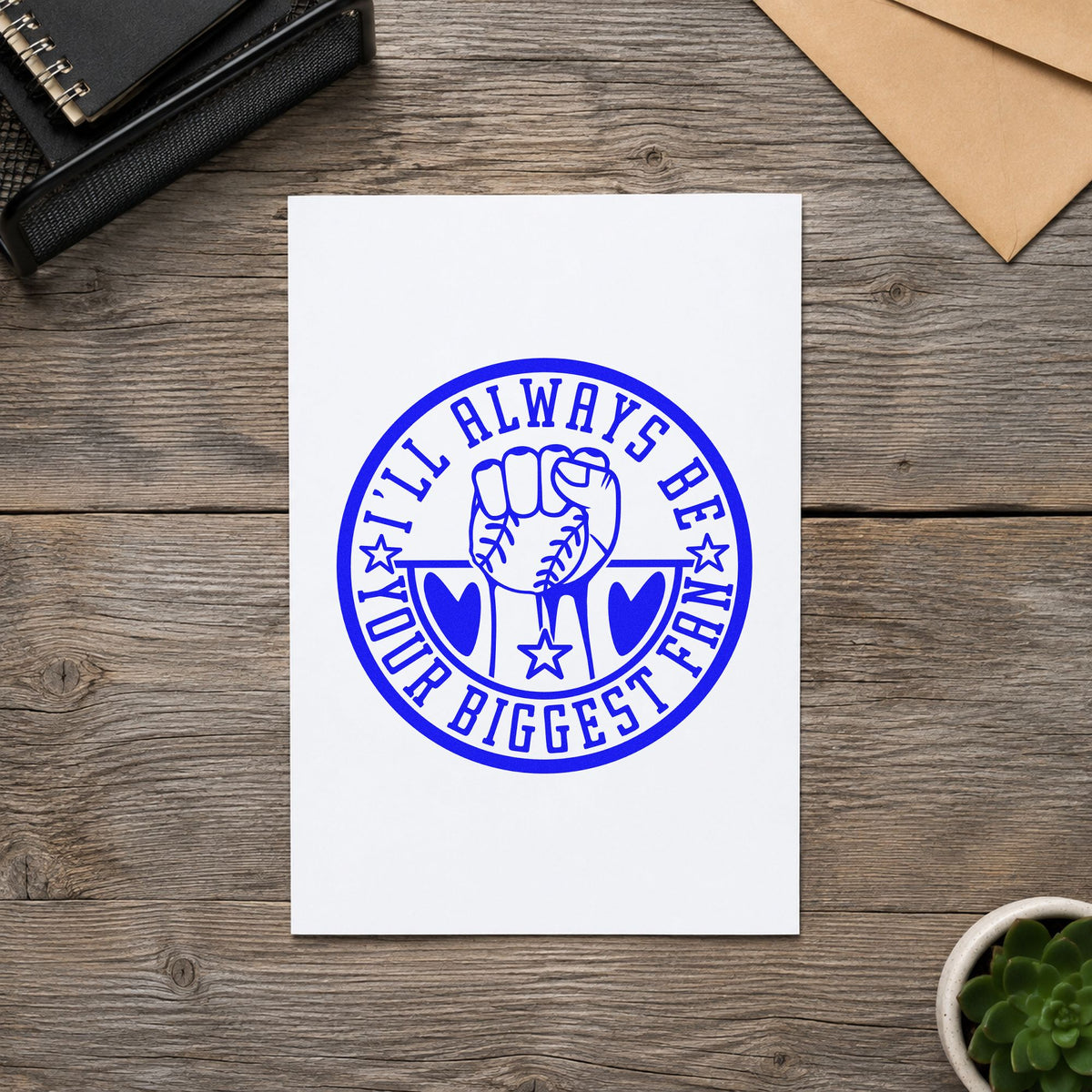 Biggest Fan Baseball Badge craft stamp imprinted in blue ink on paper, a design suited to fan tote bags.