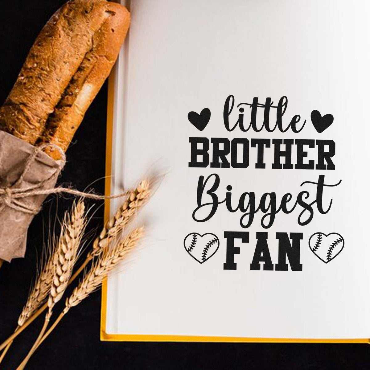 Black custom stamp/seal on white card reading little BROTHER Biggest FAN, with heart baseball icons and gold trim.