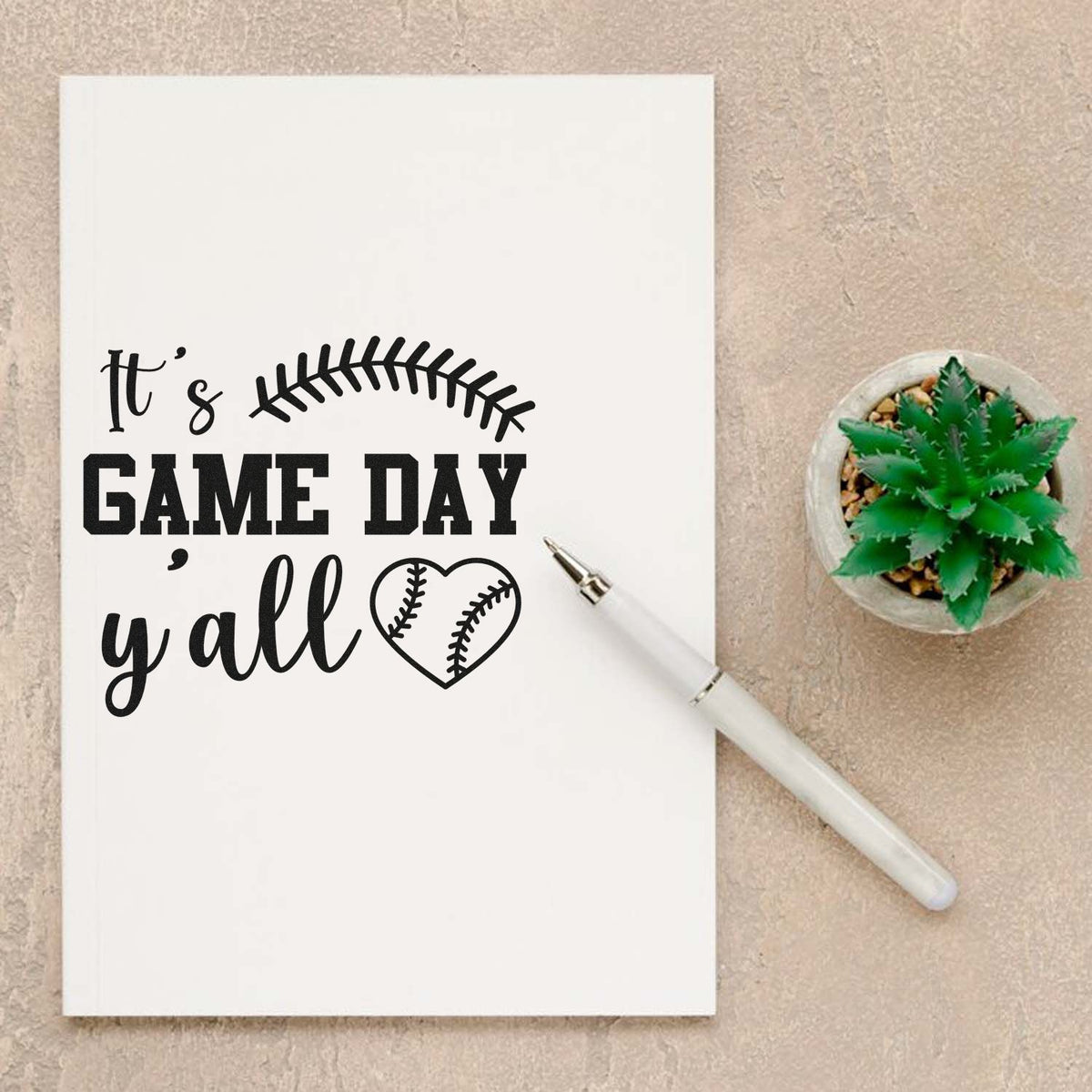 Black baseball game day stamp and seal on white card with Its game day yall text, white pen, and green succulent.
