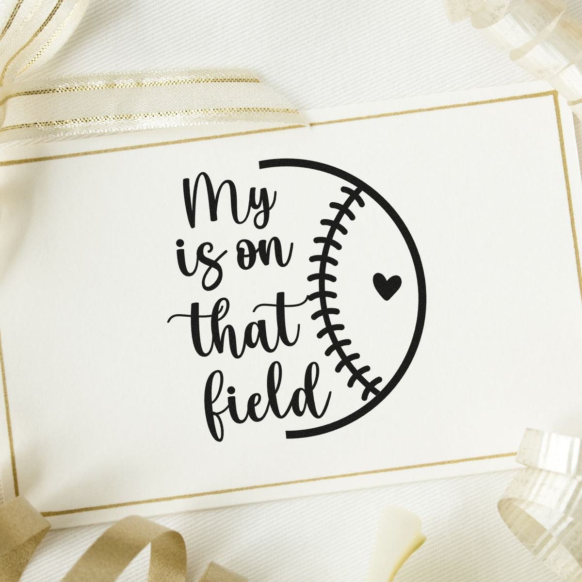 Black baseball-themed stamp and seal reading My is on that field on white card with gold trim and heart.
