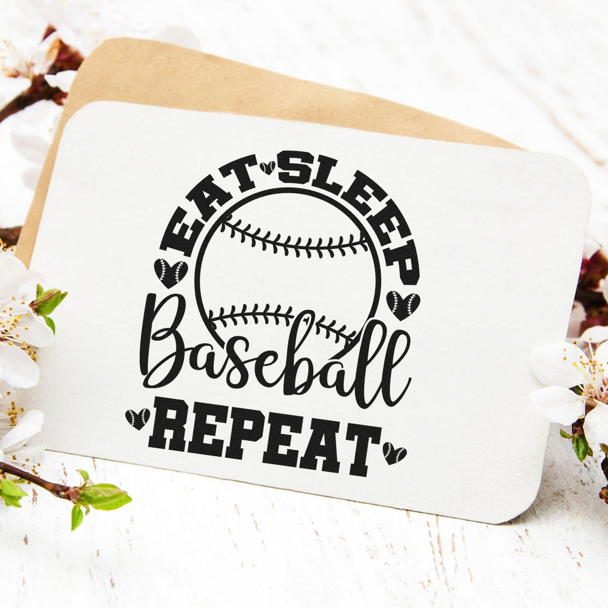 Black baseball repeat stamp and seal on white card with kraft envelope, accented by small heart icons and spring blossoms.